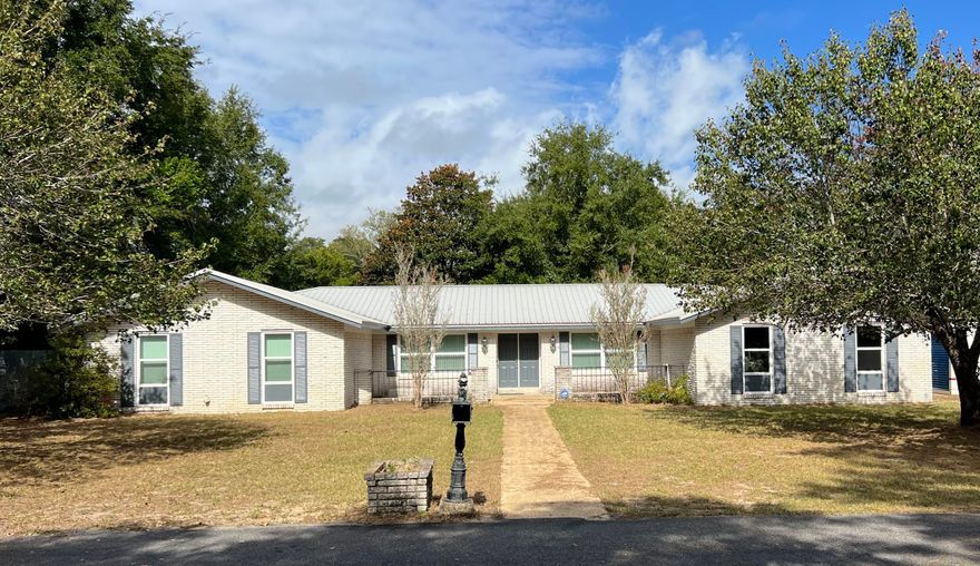 BACK ON MARKET!  Aluminum wiring is GONE!  This FANTASTIC HOME IN POQUITO BAYOU has updated KITCHEN & BATHS on a HUGE corner lot with private backyard! Laminate and ceramic tile flooring, arched walls, crown molding & spacious rooms. Formal living and dining rooms. Family area w/fireplace, French doors and Bose surround sound speakers. Huge eat-in kitchen with granite counters, a double oven & SS appliances, new microwave, and dishwasher. Large primary BR has bath with walk-in marble shower & vanity. Two add'l spacious BRs & 2nd full bath. There's a big laundry room. Screened-in back porch. Other features: Storm-rated windows and doors and a 150 MPH-rated garage door w/opener. LED lighting. Well pump w/timer on sprinklers. Full security system. Metal roof w/solar panels lower power bills.