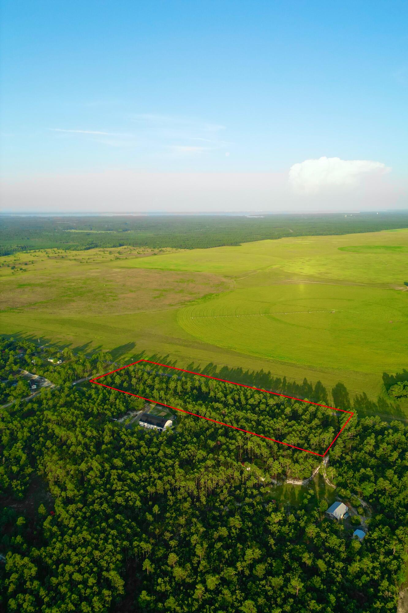 Don't miss this rare opportunity to own 5 beautiful acres on the corner of JW Hollington Road and Don Graff Road in Freeport, Florida. This spacious parcel offers a peaceful, private setting with easy access via two paved county roads, making it an ideal location for your dream home, country retreat, or future investment. The land is a blank canvas, offering a great mix of space and natural Florida woods- perfect for customizing your layout while preserving the charm of the surroundings.Located just minutes from downtown Freeport, this property offers the quiet of rural living with the convenience of nearby amenities. You'll be close to several public boat launches along Choctawhatchee Bay, providing quick access to world-class boating and fishing. Plus, the sugar-white sands of South Walton's Gulf beaches are only a short drive away, making this a perfect base for enjoying all the Florida Panhandle has to offer.
With no HOA and minimal restrictions, you'll have the freedom to build what you want, whether it's a custom home, modular residence, or even a small farm. Power is available at the road, and water and septic will need to be added, giving you a blank canvas to develop according to your needs and preferences. The generous corner lot layout also offers great flexibility for driveway placement, and outbuildings (buyer to verify with Walton County).
Freeport is one of the fastest-growing areas in the Florida Panhandle, known for its small-town feel, strong school system, and close proximity to both the bay and the beach. This property puts you within easy reach of Highway 20 and U.S. 331, making it a convenient spot whether you're commuting to work, heading to the beach, or enjoying all the natural beauty of the region.
If you're seeking space, flexibility, and a prime location in one of Florida's most desirable coastal towns, this 5-acre corner lot delivers. Come build the lifestyle you've been dreaming of in Freeport.