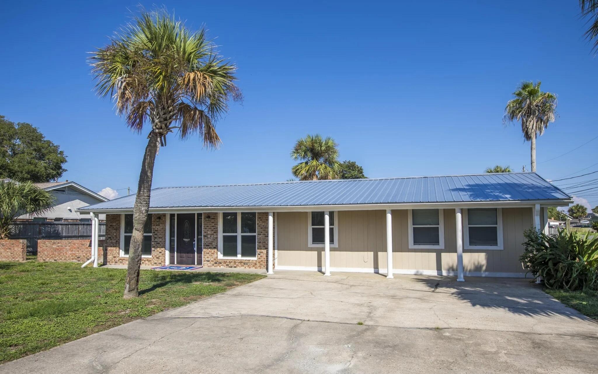 New Listing - Priced to Sell - Charming Brick Home in Open Sands | Oversized double Corner Lot | Prime Panama City Beach LocationWelcome to the highly desirable and tranquil community of Open Sands with no HOA, where you're just steps from the sugar-white sands and emerald-green waters of The World's Most Beautiful Beaches. This meticulously maintained 3-bedroom, 2-bathroom ranch-style home is perfectly positioned on a rare double corner lot, offering extra parking and ample space for a boat, carport, garage, or pool.Inside, you'll find a bright and spacious open concept living area with vaulted ceilings and large windows that fill the home with natural light. The kitchen is a chef's delight, featuring wraparound granite countertops, a peninsula with bar seating,