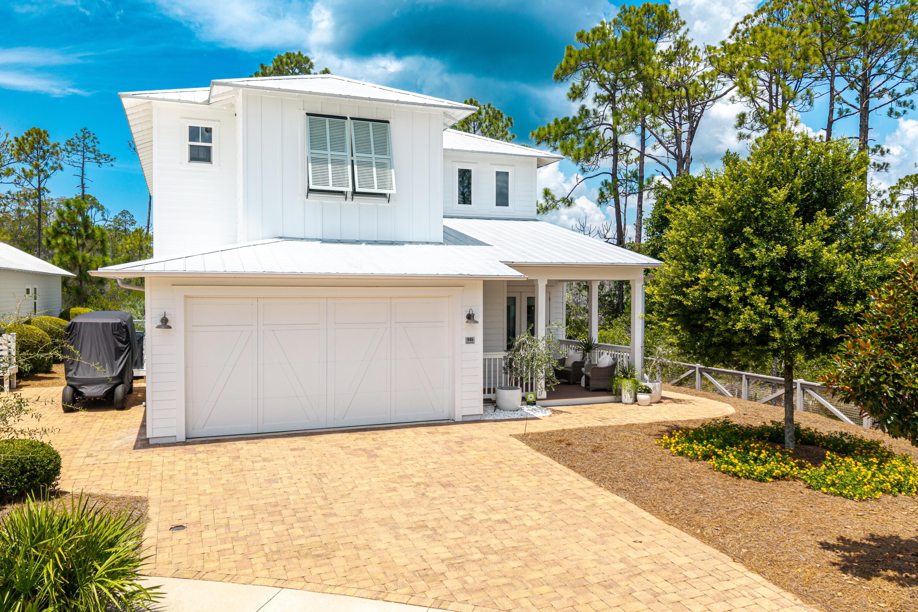 Beautifully situated on one of the premier lots in NatureWalk at Seagrove's final phase, 235 Prairie Pass offers the perfect blend of luxury, privacy, and outdoor living. Backing to a serene wooded preserve and overlooking a tranquil pond, this 5-bedroom, 4.5-bath Seagrove plan showcases thoughtful design and high-end features throughout--including a resort-style saltwater pool, outdoor firepit, and lush backyard retreat perfect for entertaining.The home's layout is both functional and elegant, with a first-floor primary suite, dedicated study (currently used as a music room), spacious upstairs loft/flex space, and 2-car garage. Soaring ceilings and large windows fill the two-story living room with natural light, enhanced by stained wood beams and V-groove paneling above the fireplace.
At the heart of the home, the chef's kitchen impresses with white shaker cabinetry (glass uppers with LED lighting), quartz countertops, subway tile backsplash, and GE Monogram appliances including a 48" refrigerator, gas cooktop, range hood, built-in oven, microwave, and dishwasher. The oversized kitchen and dining area provide ample space for gathering and entertaining.
The primary suite on the main level features a spacious bedroom, large walk-in closet, and a luxurious master bath with dual vanities, shaker cabinetry, and white quartz countertops. Upstairs, four additional bedrooms and a loft/flex space offer versatility for guests, work, or play.
Step into the backyard and enjoy a resort-inspired escape with a glistening saltwater pool, firepit, and pond views, all designed for effortless indoor-outdoor living. The home also includes several smart and energy-efficient upgrades, such as a fully automated pool system, automatic patio lighting, dedicated outdoor LSV outlet, and a 50-amp EV charging circuit in the garage.
Residents of NatureWalk enjoy access to The Gathering Place, an amenity-rich community hub featuring a heated lap pool, zero-entry pool, hot tub, fire pit, grilling stations, pickleball, multi-purpose courts, fitness trails, and abundant green space. A scenic nature trail through the forest offers direct access to the beach, placing you just minutes from the best of 30A.