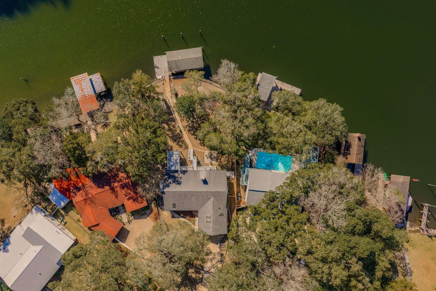 Gorgeous waterfront home on the Chula Vista Bayou with 100 feet of water frontage! This deep water lot is .39 acres and covered with palm trees and oak trees with moss!  The property features a covered boat slip accommodating up to a 6000 lb. boat, an open slip for a large boat (16 ft between pilings), and an extended dock facing the full length of the bayou! Watch the sunrises and dolphins play over emerald green water from the dock! There is a cat walk to the home that leads to an covered upper balcony (approximately 800 sq ft), a lower patio. and a paver patio.  the paver patio is perfect for entertaining guests around a firepit! The waterfront lifestyle offers paddle boarding from your dock, fishing off the dock, skiing, jet skiing, access to Crab Island on the Choctawhatchee Bay, access to the Santa Rosa Sound and much more! Take a boat to eat lunch or dinner! This home is for fishing and boating enthusiasts! the home features 2916 sq foot home, 4 bedrooms and 3 bathrooms! Enter the home through the front door with side lights into the foyer which opens into the living room, dining room, and kitchen! The open floor plan and three sliding glass doors to the balcony overlooking the bayou is perfect for indoor and outdoor entertaining. Natural light abounds in this space! Views of the bayou are breathtaking! The kitchen features a stainless, French Door refrigerator, stainless dishwasher, built in microwave, and an electric slide in oven and stove. The upgrades include granite countertops, a tiled backslash, a peninsula that seats 3-4 guests, and ample cabinet storage space. The dining room has ample space for a large dining room table. The living room is also spacious. There are hand scraped wood laminate flooring and recessed lighting. The primary bedroom is on the main floor for easy access without stairs! The room is large and has two sliding glass doors to the upper balcony. The primary bathroom features a tiled walk in shower and two large, separate vanities. The primary bathroom is finished with a frameless shower door and brushed nickel shower faucet. There are an additional guest bedroom and bathroom on the main floor. Downstairs there is a large living room with built in book cases, a fireplace and a bonus space. In addition there is a very large walk in closet for storage! This space is perfect for a pool table, home office, or add an extra kitchen and dining for multigenerational space! There are two additional bedrooms and a full bathroom downstairs. This home invites the water in!! There are sliding glass doors leading to the open patio downstairs! Just exit out of the sliding glass doors right to the paver patio and a seating area around a fire or head down to the cat walk to relax and enjoy the waterfront lifestyle from the expanded dock. There are many updates in this home such as tiled walls with brick lay in the downstairs bathroom, stained wood vanity with raised sinks, new lighting in areas, walk in shower with framed shower door, claw foot tub, updated vanities, mirrors, and faucet and fixtures. This home is a gem and is priced to sell! Buyer to verify all dimensions and information. 
