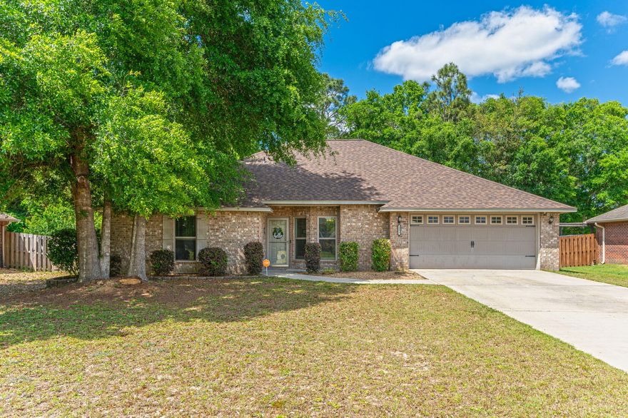 This charming all-brick home in Lee Farm, situated on a level lot in western Crestview, has been beautifully maintained and recently updated. It features four bedrooms and two bathrooms, all enhanced with luxury vinyl plank (LVP) flooring throughout. The home boasts nine-foot ceilings and an open floor plan in the main living areas, creating a spacious and welcoming atmosphere. The kitchen is a cook's dream with new stainless-steel appliances including a dishwasher, microwave, and smooth top stove/oven. It's also been upgraded with new granite countertops, 42-inch raised panel cabinetry, an under-mounted sink, and modern lighting, adding to its elegant appeal. Additionally, the home has received major upgrades in 2023, including a new roof, new AC unit, and and new water heater, ensuring peace of mind for years to come. The expansive 21 by 12-foot master bedroom is a private retreat located behind the kitchen and features a large walk-in closet and a distinctive ensuite bath with a granite-topped double vanity and walk-in shower.