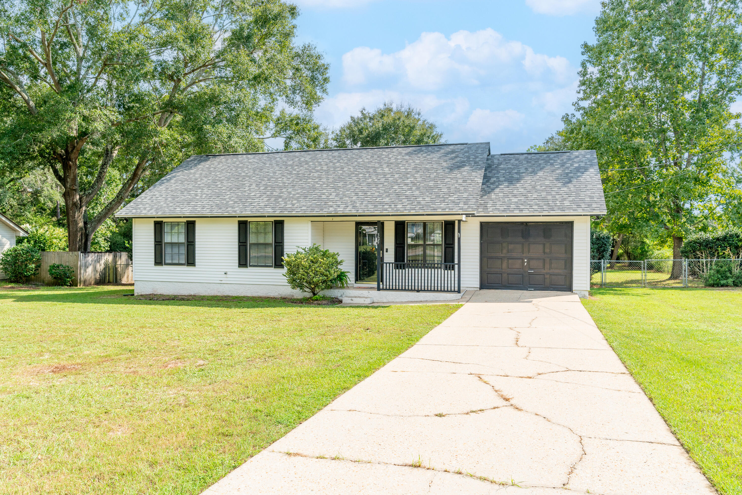 NEW ROOF (2022).. NEW PAINT.. NEW CARPETING.. NEWER HVAC (2021).. NEWER WATER TANK (2021).. AND QUICK COMMUTE TO THE BASE!Welcome to 329 John King Road! Step inside to vaulted ceilings.. cherry wood laminate flooring.. designer paint.. CUSTOM MEDIA WALL.. and a modest footprint that provides for functional/affordable living.The kitchen recently received a facelift. The owner installed new kitchen cabinets and a BRAND NEW STAINLESS STEEL REFRIGERATOR. The pantry is spacious and the dining area is light and bright! Check out the french doors leading to a BIG BONUS! More on that a little later..Both guest bedrooms boast BRAND NEW CARPET and the master suite features vaulted ceiling.. cherry laminate flooring.. and a private door leading to the bonus I mentioned earlier -THE DECK!