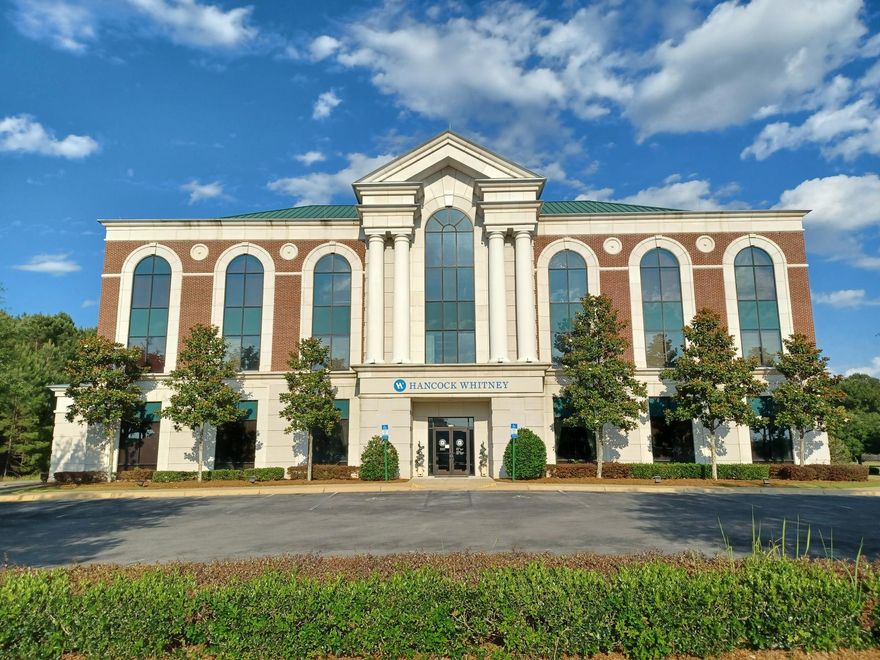 One of only a handful of Class 'A' office buildings in the Okaloosa/Walton County market. Purpose built in 2006 for a regional bank headquarters, this three story steel frame and stone structure commands immediate presence. Massive columns and in-laid brick exterior show the building's Southern roots, while floor to ceiling glass windows and metal roofing system lean towards a modern appeal. This property provides a very unique opportunity to occupy generous interiors providing local professionals a marquee office location. Further, the Landlord has budgeted up to $40/sf in Tenant Improvement Allowance to renovate the common areas and office suites. The building is fully serviced by a back-up generator, full fire suppression, multiple restrooms and dual enclosed emergency staircases.