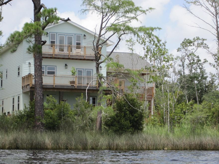 BAY FRONT HOME with UPGRADES GALORE. This Custom built, 3300+ sq ft home offers a ton of privacy, Panoramic views of the Bay, nearby Boat ramp with a dock permit in place. Features include,Over sized Kitchen with Custom Cabinets, Over sized Island,Pantry, Bosch Double Ovens and Dishwasher,48'' Kenmore Elite Refrigerator,Kenmore Elite Smooth Top Stove,Double Stainless Steel Sinks,Recessed Lighting,Surround Sound Speakers,Reclaimed Maple Floors,Master Bedroom with sitting area and wet bar,over 550 sq ft of Deck space to take in the Sunsets and Sunrises and more. Buyer to verify all information to buyers satisfaction including but not limited to sq. footage, room sizes, lot size, zoning etc. The home is also set up with an elevator shaft in place,Impact windows,2 A/C units,over sized garage with 2200 sq ft of space, outdoor shower,sprinkler system with a pump for the yard and more. Call Today for an appointment.
