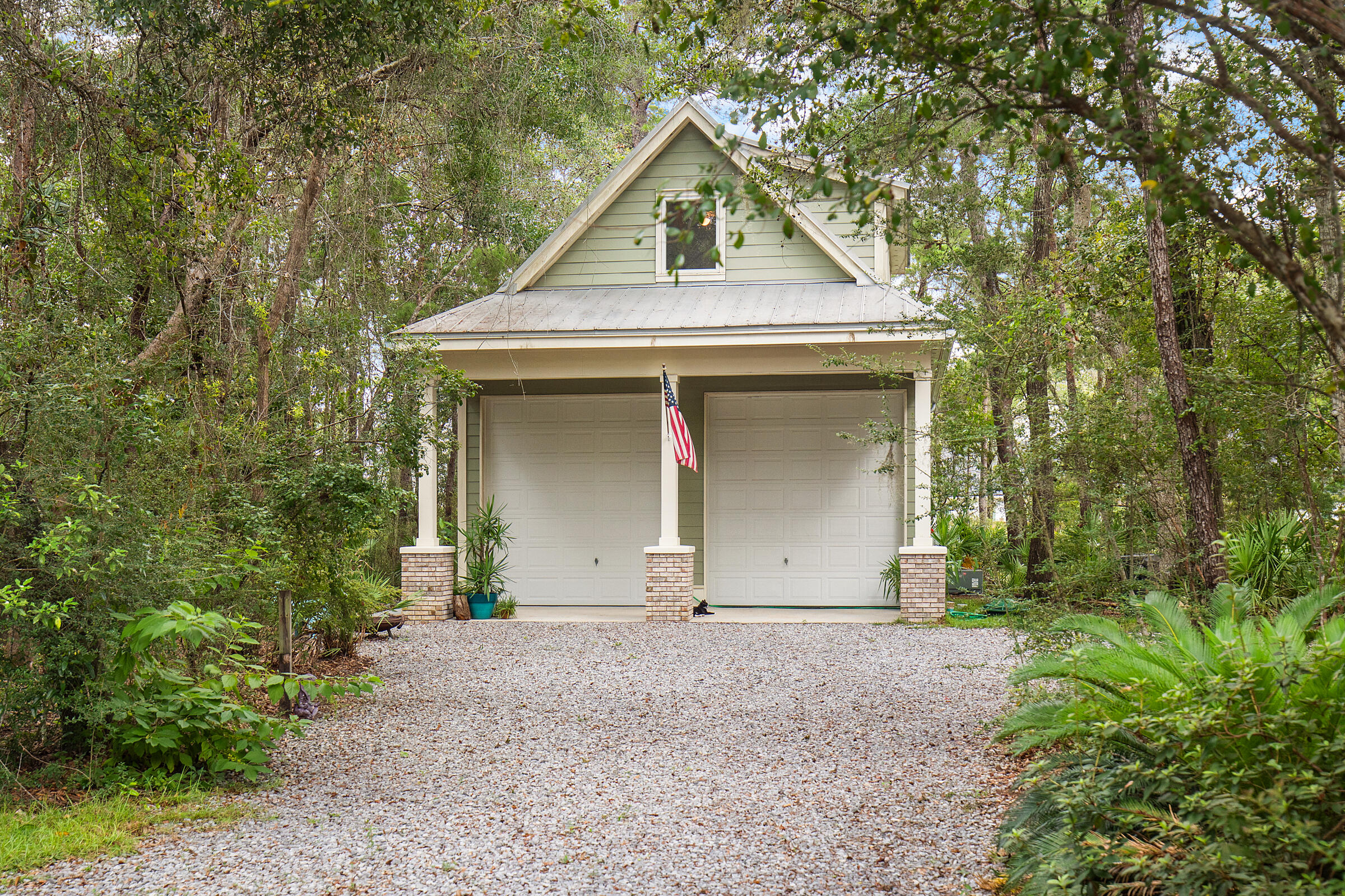 Nestled in the charming and historic community of Point Washington--one of Walton County's oldest settlements--this property offers the perfect blend of space, versatility, and location. Just minutes north of Seaside and WaterColor and less than a mile from the public boat launch on Choctawhatchee Bay at the end of Hwy 395, it's an ideal spot for boaters, beach lovers, and those seeking a peaceful, pedestrian-friendly neighborhood. Towering native trees, a circular driveway, and ample room for a pool or manicured lawn create a serene, park-like setting. The single-story main home features a smart, no-wasted-space floor plan with open kitchen, living, and dining areas, generous bedrooms, abundant storage, and a large laundry room. The spacious garage with extended ceiling and garage door heights, and a depth of 31', is perfect for housing multiple vehicles, water crafts, and recreational vehicles. Additional locked storage in the rear of the garage allows future owners the space for a safe room or to be used as an owner's closet while renters occupy the space.
Privately situated above the garage is a full one bedroom apartment, with a private entrance from the exterior, as well as garage access, you'll find a welcoming foyer that leads to the stairs of this lovely home in the trees. Windows line the main living space, flooding everything in natural light. Guests and owners can enjoy a comfortable stay with a full kitchen and large bathroom with space for a stacked washer/dryer hook up in place.
With no HOA and both short- and long-term rentals permitted, there is income potential to earn from one or both residences, or enjoy multi-generational living.
Morning bike rides to Eden Gardens State Park, afternoons on the bay, and quick trips to the sugar-white sands of 30A makes Point Washington the destination for those looking to enjoy that Old Florida ambiance. Surrounded by preserved forest land, you'll appreciate the natural beauty, lower traffic, and timeless charm of this coveted location. Call your agent today and move to where the locals love to live.