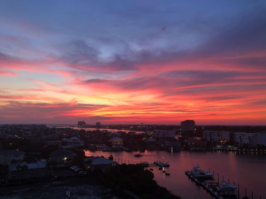 Stunning views of the Destin Harbor and the Gulf of Mexico in this 8th Floor, 2  bedroom 2 full bath condo! Imagine seeing sunsets 365 days a year! This unit has a spacious, open floor plan with high ceilings and amazing HARBOR and GULF VIEWS from the main living area and the primary bedroom. Enjoy fireworks all summer long on your private balcony. Both bedrooms have an attached bath, one of which opens to the hallway as well. The owners have upgraded appliances in the kitchen and added two additional closets in the primary bedroom. Harbor Landing has two pools (one for owner's only) and deeded beach access across the street. You will love this as a primary home, 2nd home or a rental investment. This unit comes with one covered parking space, storage and has 10th floor views.