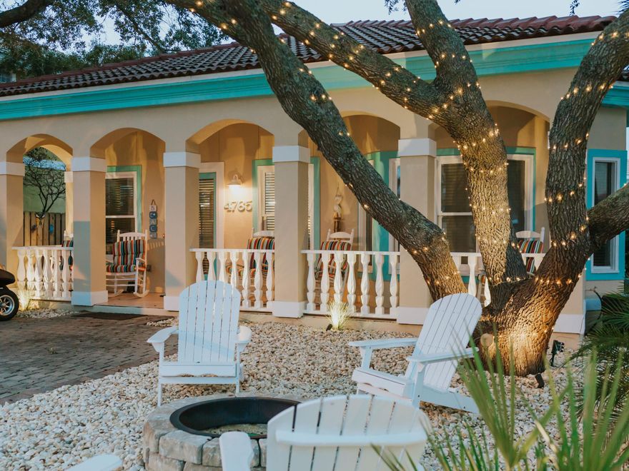 This quintessential beach cottage is in a quiet cul-de-sac just a short walk from the private beach access. It greets you with a paved driveway for parking your golf cart, a  full-width covered porch and a cozy firepit surrounded by Adirondack chairs. It's the perfect spot for enjoying gentle sea breezes or toasting marshmallows beneath the stars. Step inside this tastefully furnished home and check out the spacious open floor plan with wood tile flooring and airy vaulted ceiling. The sitting area has plush furnishings and an enviable entertainment center for putting your feet up and sharing quality time with family and friends. There's a natural flow into the dining area and well-planned kitchen which has granite countertops and stainless steel appliances. Through the kitchen you can access the oversized raised deck which provides a gorgeous living space for alfresco dining and relaxing. 
After a fun day at the beach, the outdoor shower is a thoughtful addition for rinsing sandy feet of kids and pets. Then, it's time for a luxurious wallow in the steaming hot tub before lighting up the barbecue for dinner. The split floor plan includes a spacious master with ensuite, a well-appointed bunk room, a further guest bedroom and family bathroom. Renters love the convenient location and spacious accommodation that deceptively sleeps 12, thanks to the queen sleeper sofa in the living room. There's plenty to do nearby including tennis courts, community pool and beach volleyball court. With a strong rental history grossing $76,000 to $83,000 per year, this fully-furnished vacation home makes an attractive investment if you don't want to keep it all to yourself.