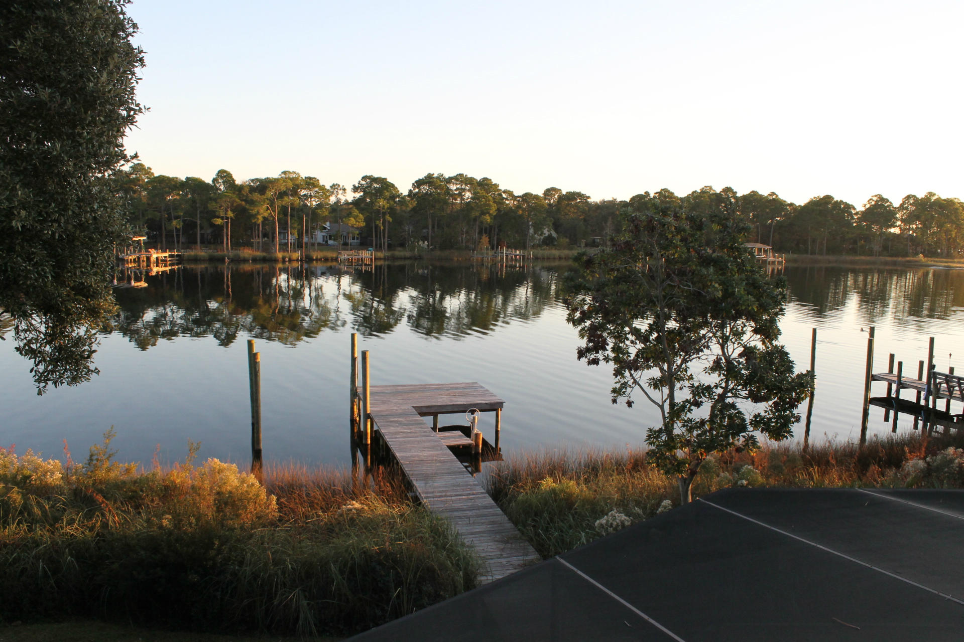 Seller says bring an offer!!! All reasonable offers will be considered. Exceptional custom waterfront home, which has new appliances, new interior paint and two new A/C systems. This waterfront home is located on Grass Lake in the gated community of Southwind. Grass lake is a tidal lake, which has direct access to the Choctawhatchee Bay. Dock can accommodate a boat and jet ski. The exterior stucco was painted with elastomeric paint 2003, and the roof was new in 2005. The lanai and heated gunite pool are screen enclosed. The lanai is very large and is perfect for entertaining. The open design interior focuses on water views all the way from the lustrous solid mahogany front door as well as from almost every other room.