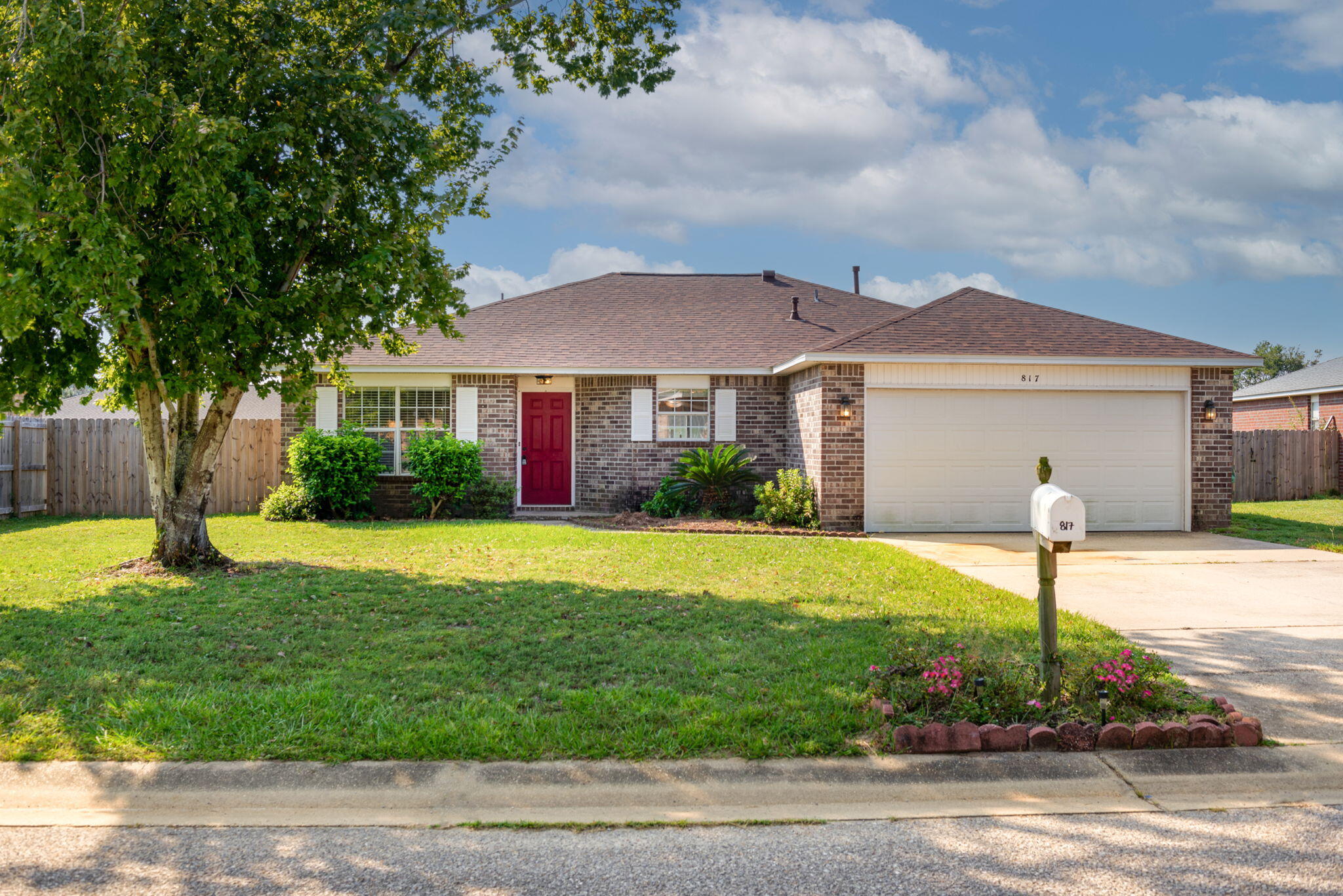 Check out this charming contemporary ranch home located in the pleasant Emerald Shores subdivision! This home has much to offer any first time or experienced buyer and is located a short distance from all the best beaches, shopping, and NAS. The home has been well conserved as you will notice upon arrival to the inviting setting and attractive grounds. You'll find a shaded front lawn that is landscaped with shrubberies and easy-care brick exterior that is accented with white shutters that gives way to the homes quaint character and adds an alluring approach. Your welcomed home by a generous tiled foyer and adjoining bonus space to the left that would make a perfect den, office, or formal dining area. You are led by the tiled foyer to a perfect open concept main living space that features
