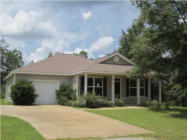 Corporate Owned! This fantastic 3 bedroom 2 bath home is a mile or 2 off of Hey 331 and just North of Defuniak Springs. This home offers a great open floor plan, a large lot and a single car attached garage. There is wood laminate flooring in the main living areas, carpet in the bedrooms and tile in the baths. The master suite has its own access to the covered patio. The master bath has two separate vanities and separate shower. The main living area is open to the dining area and kitchen with a nice breakfast bar along the kitchen island. The kitchen offers custom oak cabinets, recessed lighting, with the breakfast bar. This beautiful home is almost like new inside! Property is being sold without appliances or A/C condenser.