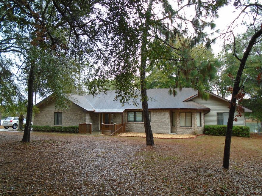 LAKEFRONT ON GRAND LAKE - Beautiful Home located just off Airport Rd. Home features wood burning fireplace in living room, updated 20 x 21 kitchen with solid countertops, island plus breakfast bar. Additional counter with cabinets in the breakfast nook area plus a walk-in pantry. Dining room features a built in buffet with cabinets. Separate home office with French Doors. Master Bedroom overlooks the Lake with a bath suite plus 7 x 9 walk-in closet with shelving. Also opens to the screened porch. The step down living room features a stone wood burning fireplace with gas igniter. To enjoy the outside is a 30 x 18 screened porch plus a 31 x 9 deck. Portion of the backyard is fenced. 2 car garage with 72 gallon water heater. Inside laundry. This is the home for you. Under roof - 3,297 sq ft