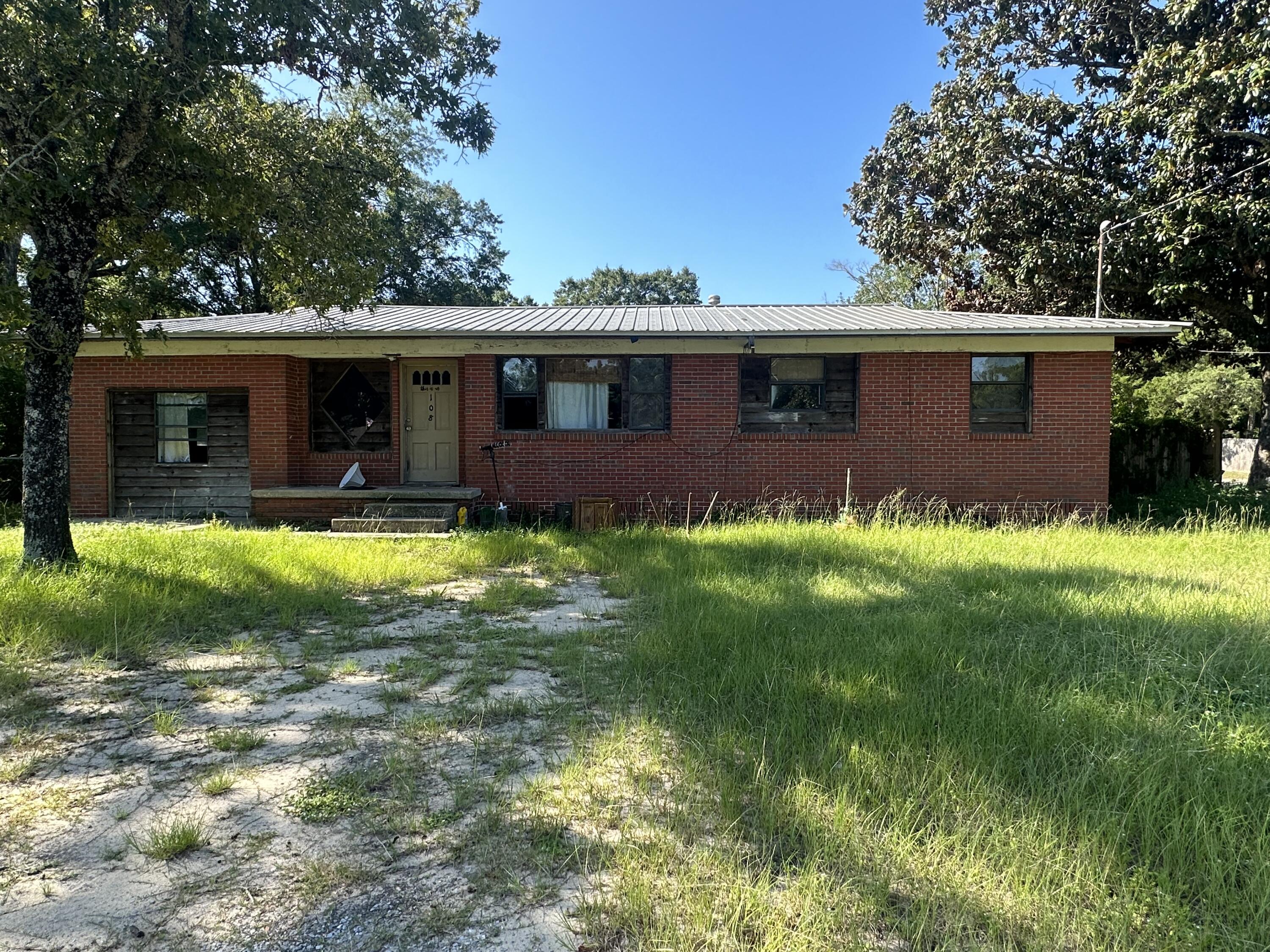 Fixer Upper ! Brick, Metal Roof, Hardwood Floors, Large Corner lot!
