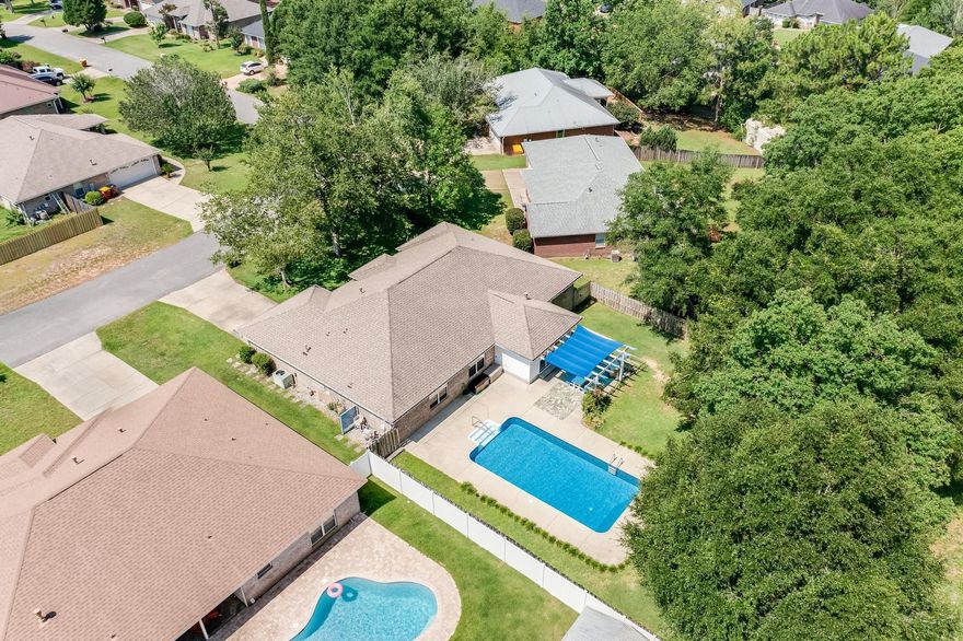 You don't want to miss this wonderful new listing in South Crestview! The beautiful 4 bedroom, split floor plan boasts a private saltwater pool giving you space to meet with family & friends & grill on the outdoor master grill setup! New pool liner 2021 & the pool plumbing was redone 2023. The spacious living area, creating an inviting and airy atmosphere extending throughout the Florida room.The kitchen boasts granite countertops, all stainless steel appliances, oversized 4 drawer Samsung  fridge plus a gas stove with double ovens, and a breakfast nook plus lots & lots more. The backyard being fully fenced provides a safe area for the kids and the family dog to run around and play in plus the neighbor has horses making you feel like your in the countryside and not 5 minutes from