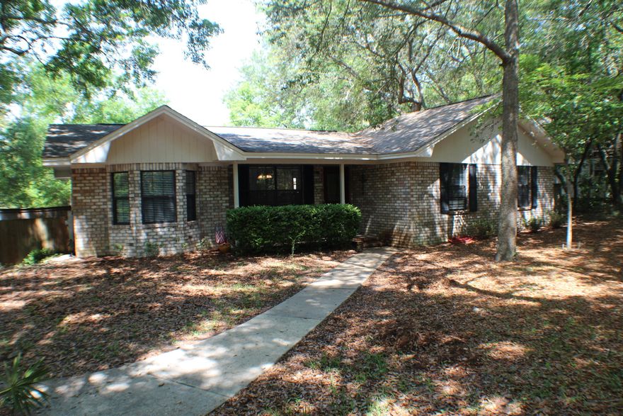 Welcome to your quiet retreat tucked away in a peaceful neighborhood off the beaten path. As you approach this home you will notice your covered porch with cypress ceiling, perfect to fit a bistro table and enjoy these warm mornings. As you enter the home you are greeted by a functional open floor plan. To your right is the full hall bathroom and two additional bedrooms. Further down the hall is the master suite with tons of sunlight and the master bathroom that has a stand up shower and built-in shelving for plenty of storage. Back through to the foyer area, the formal living room opens up to the dining room and kitchen. Granite countertops, stainless steel appliances, and tile flooring give this kitchen a cool feeling and the window above the sink brings in the perfect amount of