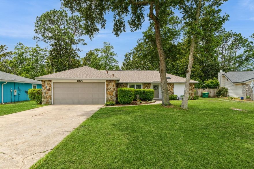 Welcome to this beautifully updated 3-bedroom, 2-bathroom home situated on over a quarter-acre lot with no HOA! Step inside to an inviting open floor plan featuring a fully renovated kitchen with white shaker cabinets, a spacious island, vaulted ceilings, and a stunning stone fireplace. Upgrades abound with luxury vinyl plank flooring throughout, impact-rated windows, modern interior doors, updated light fixtures, and fresh paint. The generous backyard is fully privacy-fenced and includes a storage shed. Major updates include a new roof in 2022, hot water heater in 2020, and a termite bond for added peace of mind. Enjoy access to the neighborhood boat launch--perfect for Florida living!