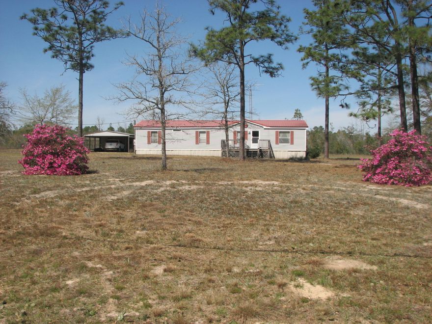 THIS ONE OWNER MANUFACTURED HOME OFFERS PLENTY OF SPACE AND PRIVACY ON 2 FLAT ACRES, YET ONLY MINUTES FROM TOWN. DETACHED WORKSHOP WITH 2-CAR COVERED PARKING, DECK ON THE BACK FOR RELAXING IN THE EVENINGS, PORCH ON THE FRONT AND SIDE. INSIDE YOU WILL FIND A LARGE GREAT ROOM WITH WOOD BURNING FIREPLACE, SPLIT BEDROOM FLOOR PLAN, SOAKING TUB IN MASTER BATHROOM, GOOD SIZE CLOSETS IN ALL BEDROOMS. OWNER IS LEAVING REFRIGERATOR AND WASHER. METAL ROOF PUT ON IN 2005, SEPTIC TANK PUMPED IN 2015, SECURITY SYSTEM IN PLACE. CALL TO SEE TODAY!