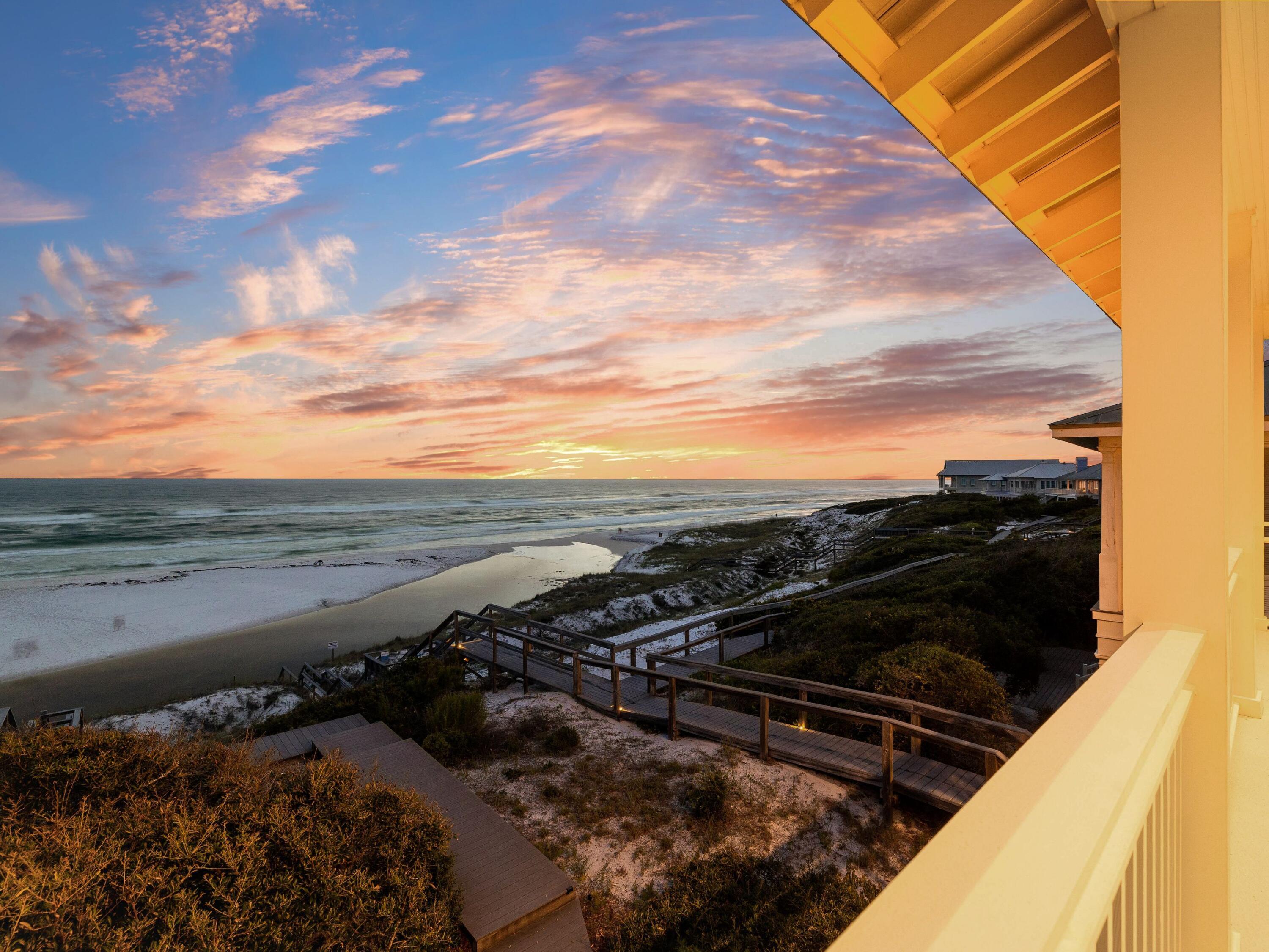 Presiding over serene dune, lake and gulf views, this quintessential beach house is in an exclusive private beach neighborhood. It comes with its own coveted Trex-plank walkover to the pristine white beach. Airy 12-ft. ceilings with dark wood beams enhance the great room, while the updated chef's kitchen boasts granite countertops, stainless appliances and an island with a cooktop. Perch on stools at the lengthy bar for casual dining and conversation. Tile floors and double-aspect windows invite you to a large screened porch with panoramic views extending across Draper Lake and the Gulf of Mexico. The oversized balcony on the second floor is perfect for laid-back entertaining and toasting sunsets from this enviable location. Four of the six bedrooms share the same breathtaking gulf views This exclusive gated community has a network of trails for exploring and wildlife spotting. There's a heated community pool and a dock for paddle boarding, kayaking and fishing on the freshwater coastal dune lake. All this, just a short walk to Gulf Place shopping and dining.