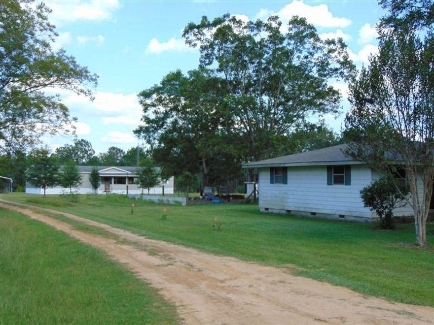 What a find! 2 homes on 10 acres with spring fed pond in back yard. Creeks & streams running through back of property. Ext features include a 32x56 pole barn (water & electric), 11x15 feed shed, 11x15 chicken house. The '08 Fleetwood home has been immaculately maintained. Interior features include fireplace; kitchen island; double vanities, garden tub & separate shower in master bath; 8.5x14.5 walk-in closet; all appliances, including deep freeze. There is a 9.5x24 covered porch and 9.5x11.5 deck, carport...