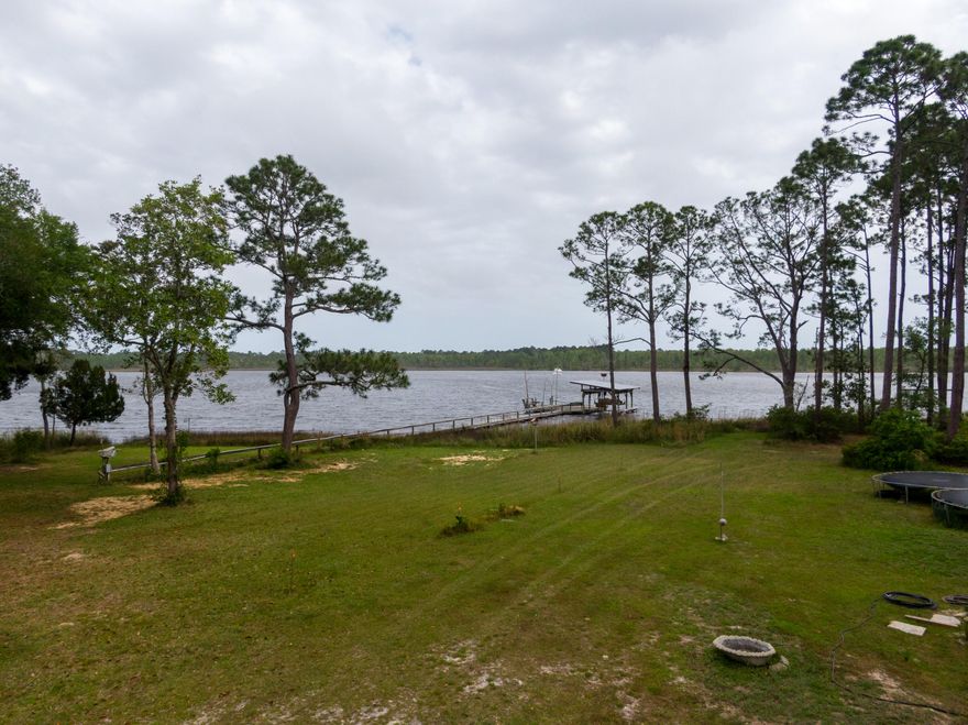 You are the artist and your canvas awaits! Rare opportunity to own just over 3 acres on the water! What a beautiful piece of property to build your dream home with water views of East Bay and East Bay River. Boasting 160 feet of water frontage, this property offers the opportunity for you to have the best of both worlds- waterfront with a little country living twist! No HOA