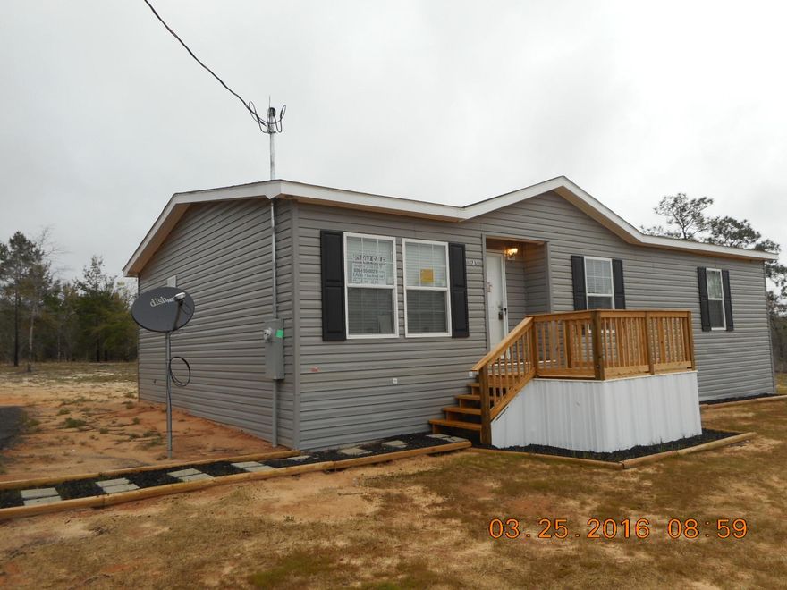This home is REO. DRASTICALLY REDUCED!! Originally listed at $96,900. Almost new 2015 beautiful home in mint condition. Carpet is new and home still has new smell when you walk inside. New front deck. Newly built steps and platform porch on back. Almost one acre of land. Asphalt driveway recently poured. Conveniently located near Defuniak Springs, yet private settings with no neighbors. Home has split bedroom floor plan, large living room, spacious kitchen, formal dining room. Home has extra touches such as arched doorways in the living/kitchen/dining area. Appliances include smooth top stove, side by side refrigerator, built in microwave and dishwasher. This home is the closest you can get to brand new. Priced to sell! Financing available through seller. Call today.