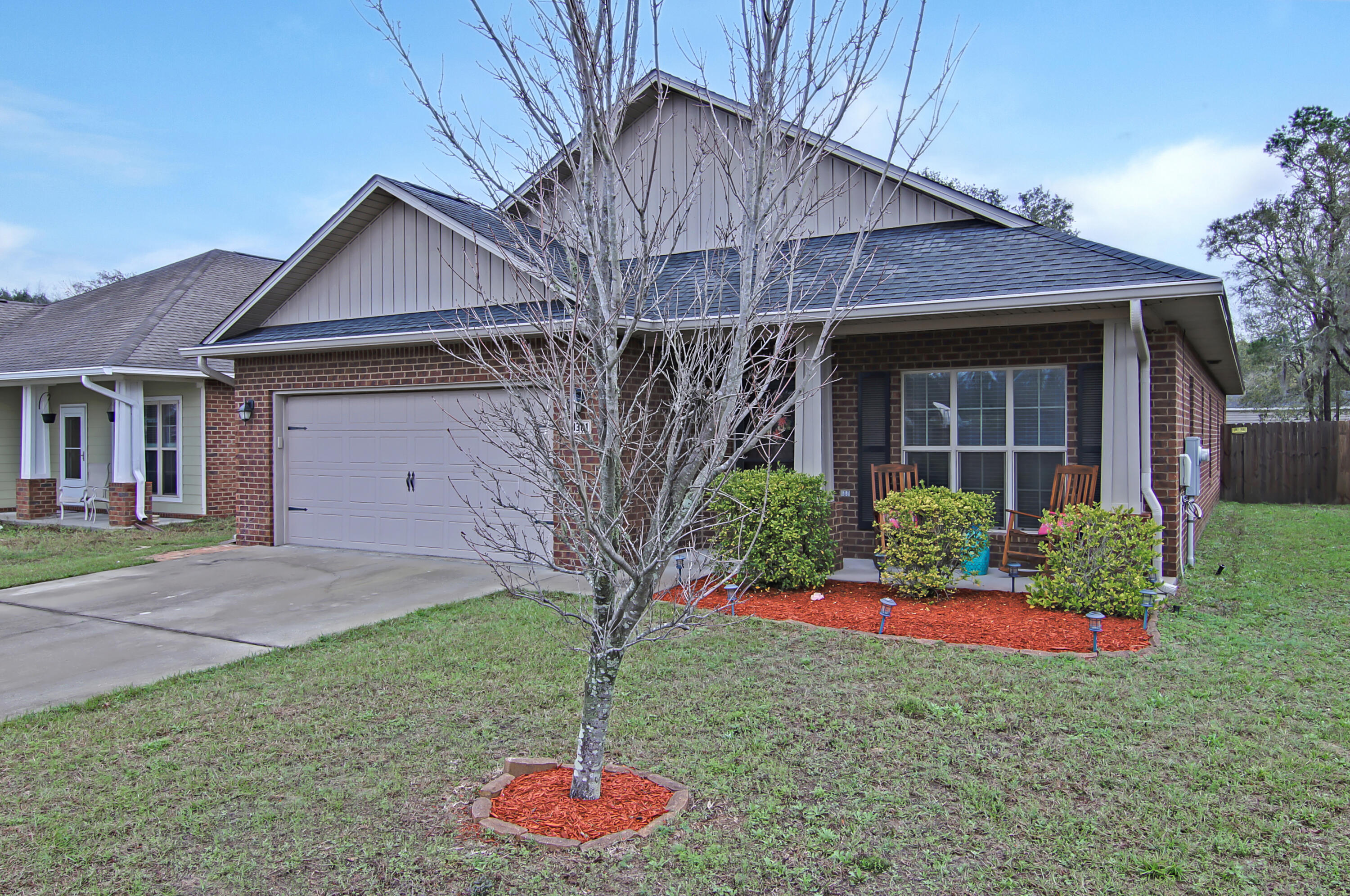Now you see it, now you don't! This captivating 4-bedroom, 2-bathroom craftsman is located in Navarre's Riverview Estates community. The home is an easy commute to shopping and dining options, Holley Navarre primary K-2, Holley Navarre intermediate 3rd-5th, and Holley Navarre Middle 6th-8th, and parks/open spaces. Exterior includes inviting patio, and breezy front and back porches. Within, you'll find a grand entryway, an open floor plan with LVP flooring throughout, stylish barndoors, neutral decor, and notable ceiling styles, including tray in the master bedroom and minimalist flat. Stylish kitchen brims with attractive peninsula layout, newer dishwasher and oven replaced in 2020. The serene master bedroom includes a walk-in closet, private bath with separate tub, step-in shower