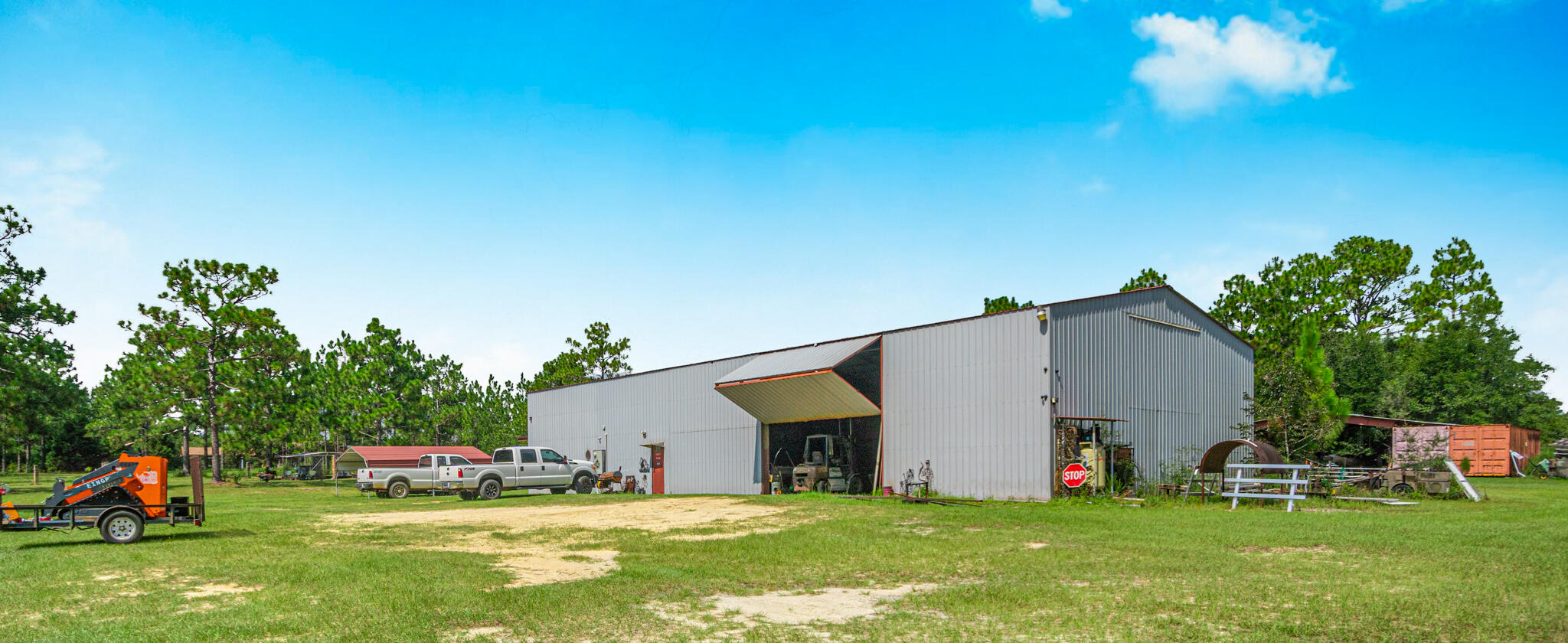 Disclosures: 1.Broker has ownership interest in this property. 2. This is also listed in the Residential MLS # 956704. 3.  Owners offering seller concessions up to $100,000.00 for down payment assistance, closing costs, etc. if needed.  4. No animals were harmed for displays, faux furs & mount purchased.     Currently a fully operational welding shop, this building can easily be converted for any type of business.  Only 30 minutes to the sugar sand beaches of the Emerald Coast and approximately 2 miles to Interstate 10, this is a prime location.  All equipment listed including 2 fork lifts, welders, metal loaders, iron worker tools, etc will convey with sale.  Full list of equipment and furnishings in documents. Please click on more for additional info. (EQUIPMENT LISTS ETC IN DOCUMENTS Home also features smart apps, including smart tv, stove, thermostat, chicken door on coop, cameras & vacuum cleaner. These things can all be done remotely with your phone.  This is a great opportunity to step into business for yourself. 
 If you want another type of business it is easy to convert or you can use extra 74x42  shop space for additional bedrooms and living space.  Business taxes for the last 2 years available with profit and loss statement. The concrete is 4 inches thick throughout with 4 ft deep tie downs in shop.  Take a look at the documents for additonal door height, shop measurements and door sizes.  Shop has 4 doors that open up.  The contents of the house including furniture can convey with sale with some exclusions.  Featuring barndominium living at its best, and located right off Business Hwy 331 S., this is a prime location to live and have a business. 