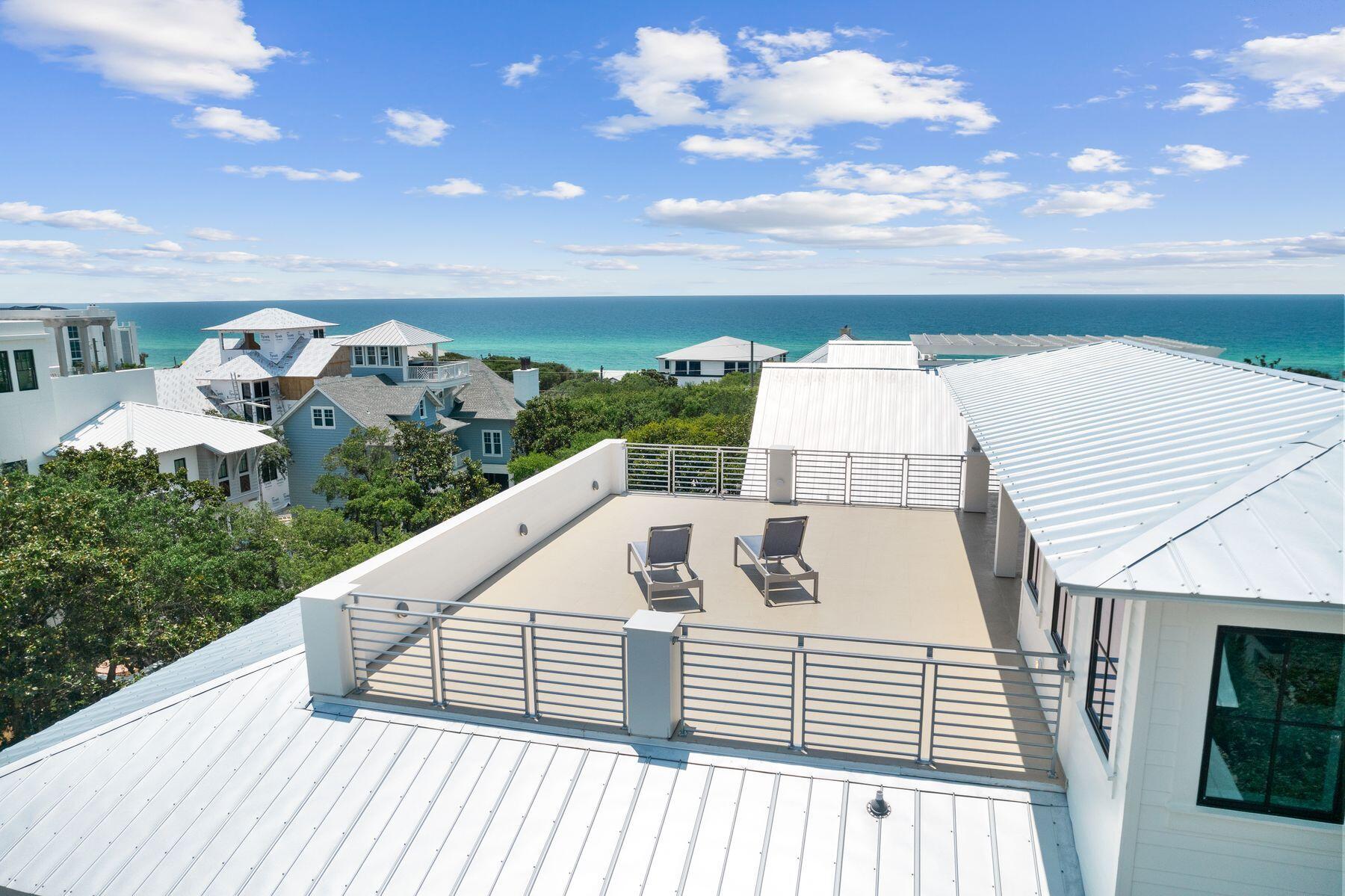 Welcome to 57 Azalea Street, a beautiful beach retreat located in Old Seagrove. This home offers luxury coastal living with two public beach accesses just 250 steps away. The home features 8 bedrooms and 8.5 bathrooms, plus a private resort-style pool, outdoor kitchen, dining area, bar space, rooftop deck with Gulf views, game room, and an elevator. The first level features a family entertainment area with a large game room. It also includes a guest bedroom with an ensuite bathroom and a bunk room with three Queen-over-Queen bunks and a shared shower. On the second level, the open living area combines elegance and comfort. The gourmet kitchen has high-end stainless steel appliances, a large marble-topped island, and custom cabinets. Step outside to the spacious terrace and take in the views of the resort-style pool and hot tub, which look beautiful at any time of day. In the primary suite, a king-sized bed welcomes you to relax. The ensuite bathroom feels like a spa, featuring a deep soaking tub, a large walk-in shower, and double vanities. There are also Twin-over-Twin bunk beds for extra guests. The third level focuses on guest comfort and privacy. It includes an additional primary suite with a private bathroom that has a shower and soaking tub, three guest suites with private bathrooms, and a two-twin bedroom with a private bathroom. End your day by enjoying a cocktail on your private rooftop deck as you watch the stunning sunset paint the sky with gold and pink colors. This luxury beach home represents elegance, comfort, and modern style. Experience the best of coastal living, where every detail is carefully designed.