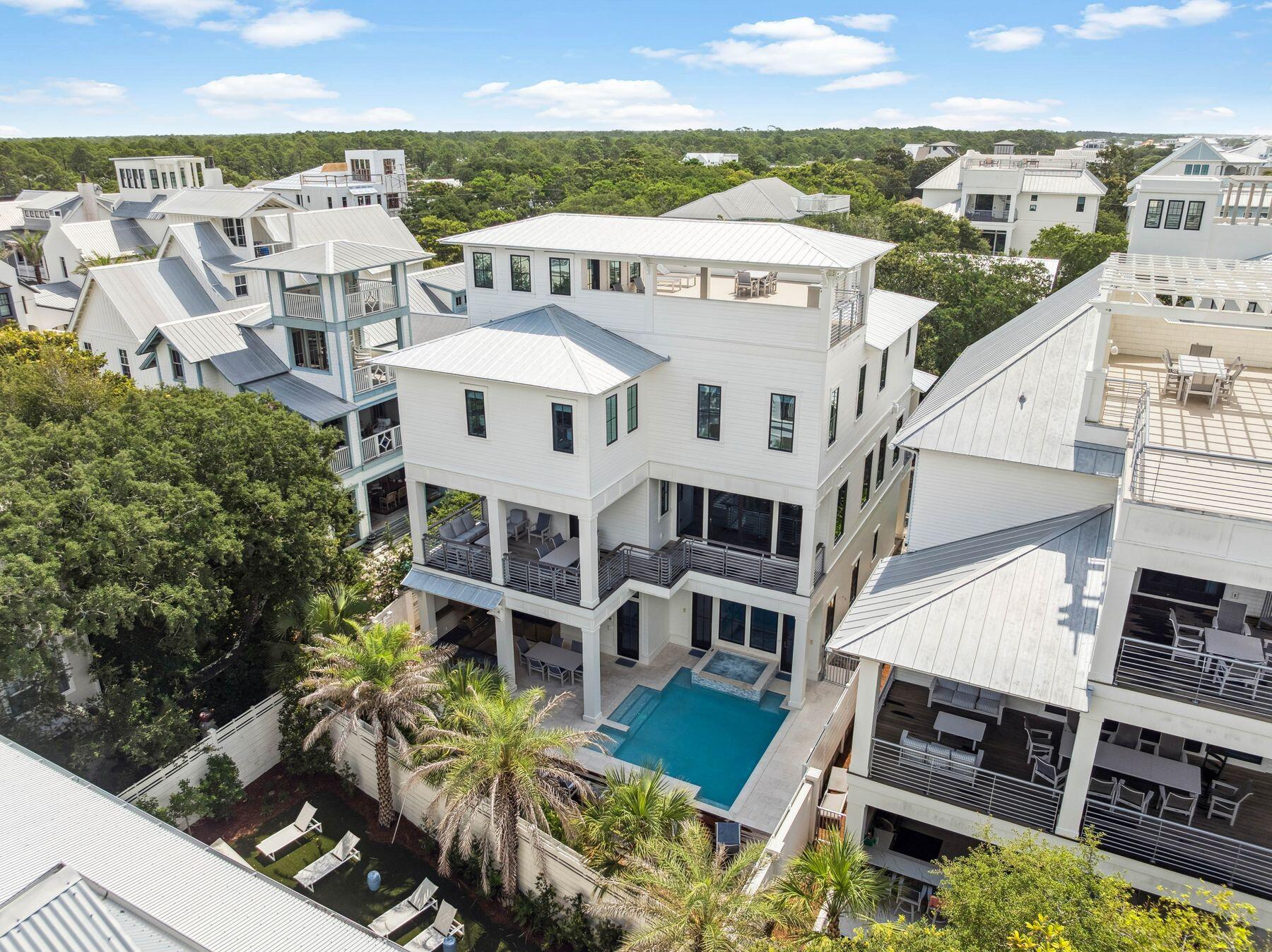 Welcome to 57 Azalea Street, a beautiful beach retreat located in Old Seagrove. This home offers luxury coastal living with two public beach accesses just 250 steps away. The home features 8 bedrooms and 8.5 bathrooms, plus a private resort-style pool, outdoor kitchen, dining area, bar space, rooftop deck with Gulf views, game room, and an elevator. The first level features a family entertainment area with a large game room. It also includes a guest bedroom with an ensuite bathroom and a bunk room with three Queen-over-Queen bunks and a shared shower. On the second level, the open living area combines elegance and comfort. The gourmet kitchen has high-end stainless steel appliances, a large marble-topped island, and custom cabinets. Step outside to the spacious terrace and take in the views of the resort-style pool and hot tub, which look beautiful at any time of day. In the primary suite, a king-sized bed welcomes you to relax. The ensuite bathroom feels like a spa, featuring a deep soaking tub, a large walk-in shower, and double vanities. There are also Twin-over-Twin bunk beds for extra guests. The third level focuses on guest comfort and privacy. It includes an additional primary suite with a private bathroom that has a shower and soaking tub, three guest suites with private bathrooms, and a two-twin bedroom with a private bathroom. End your day by enjoying a cocktail on your private rooftop deck as you watch the stunning sunset paint the sky with gold and pink colors. This luxury beach home represents elegance, comfort, and modern style. Experience the best of coastal living, where every detail is carefully designed.
