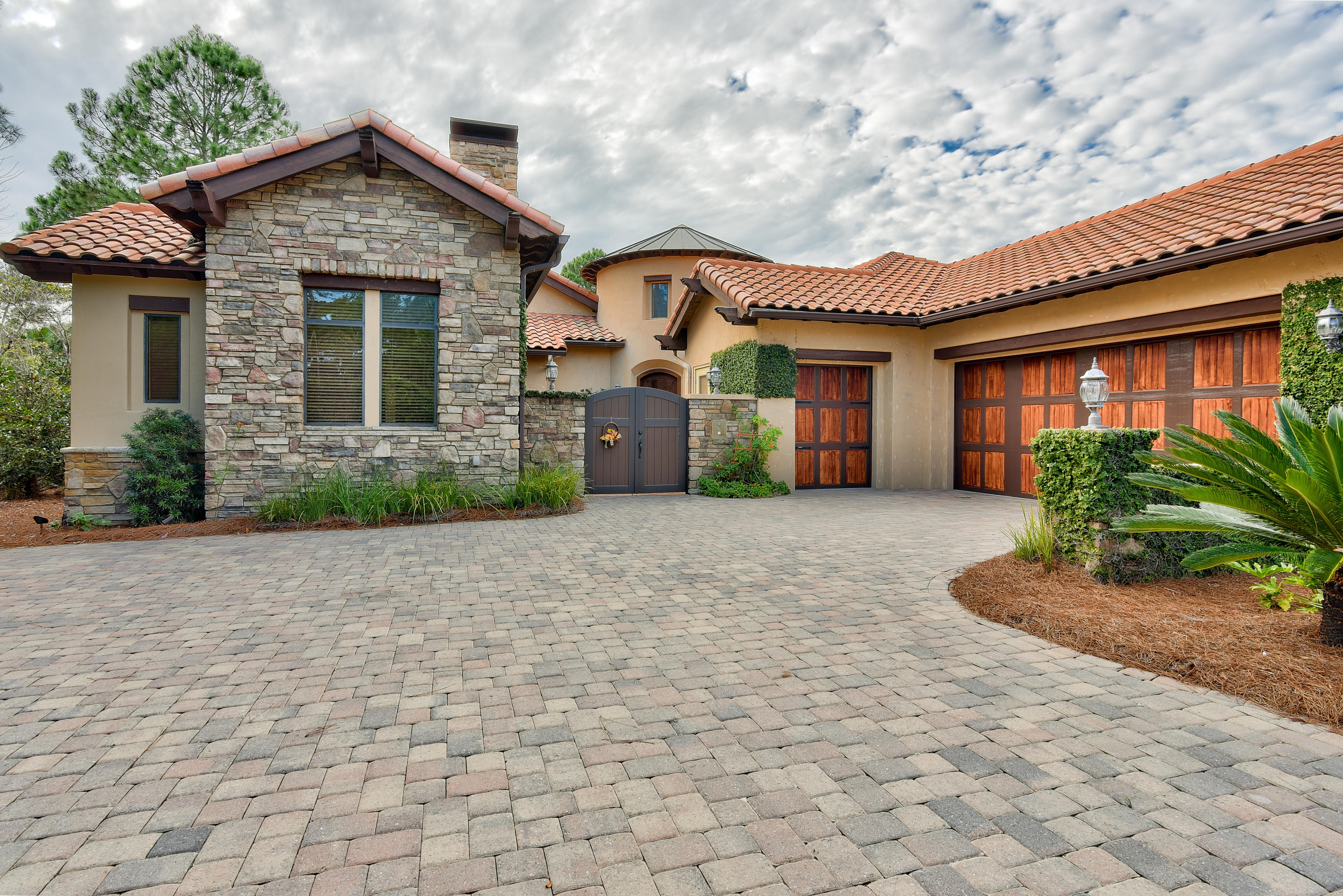 Remarkable Tuscan inspired home located on the 2nd Fairway of the Burnt Pine Golf Course. Exceptional design and architectural features are evident throughout. A quaint courtyard greets you upon entering through the wood gate. Ideal home for entertaining. Gourmet kitchen that's fit for a chef with barrel ceiling inlaid with brick. Sliding glass doors stack back to open the home to the lanai. Office can easily be transitioned to fourth bedroom. The Master Suite features a wet bar, his and hers separate baths and walk in closets, and doors leading to the outdoor living area complete with summer kitchen and gas fireplace. Full two car garage with separate golf cart door provides plenty of storage space in addition to parking. Separate entrance to the mother in law suite.