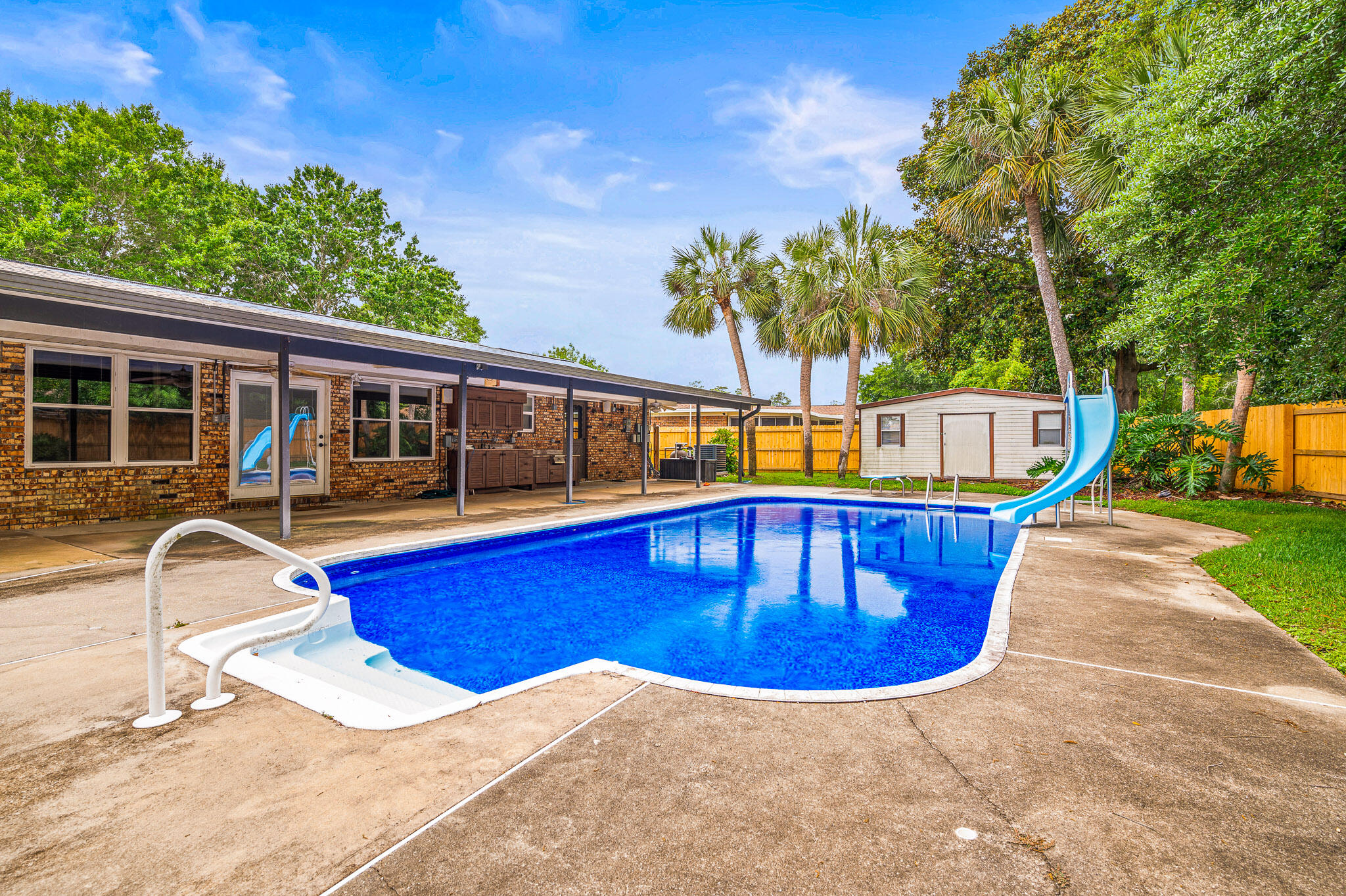 This impressive 4 bedroom 2 bath Kenwood brick home has been previously updated with a new 2025 wooden fence, 2025 refrigerator 2024 shingle roof, 2024 solar panels, 2024 27mm vinyl pool liner, new within 3 years a whole house Generac generator with Generac transfer switch, updated copper wiring, newer water heater, energy efficient 3 speed pool pump, gas logs for the interior fireplace, newer AC system, updated flooring with no carpet. The massive kitchen has solid wood cabinets, with granite counter tops throughout. The location is on a very quiet dead-end road for low traffic noise along with the safety for your kids playing in the yard. In addition to all of the this, there is covered boat/RV parking and an outdoor kitchen, plus a large storage shed for your tools/pool toys.