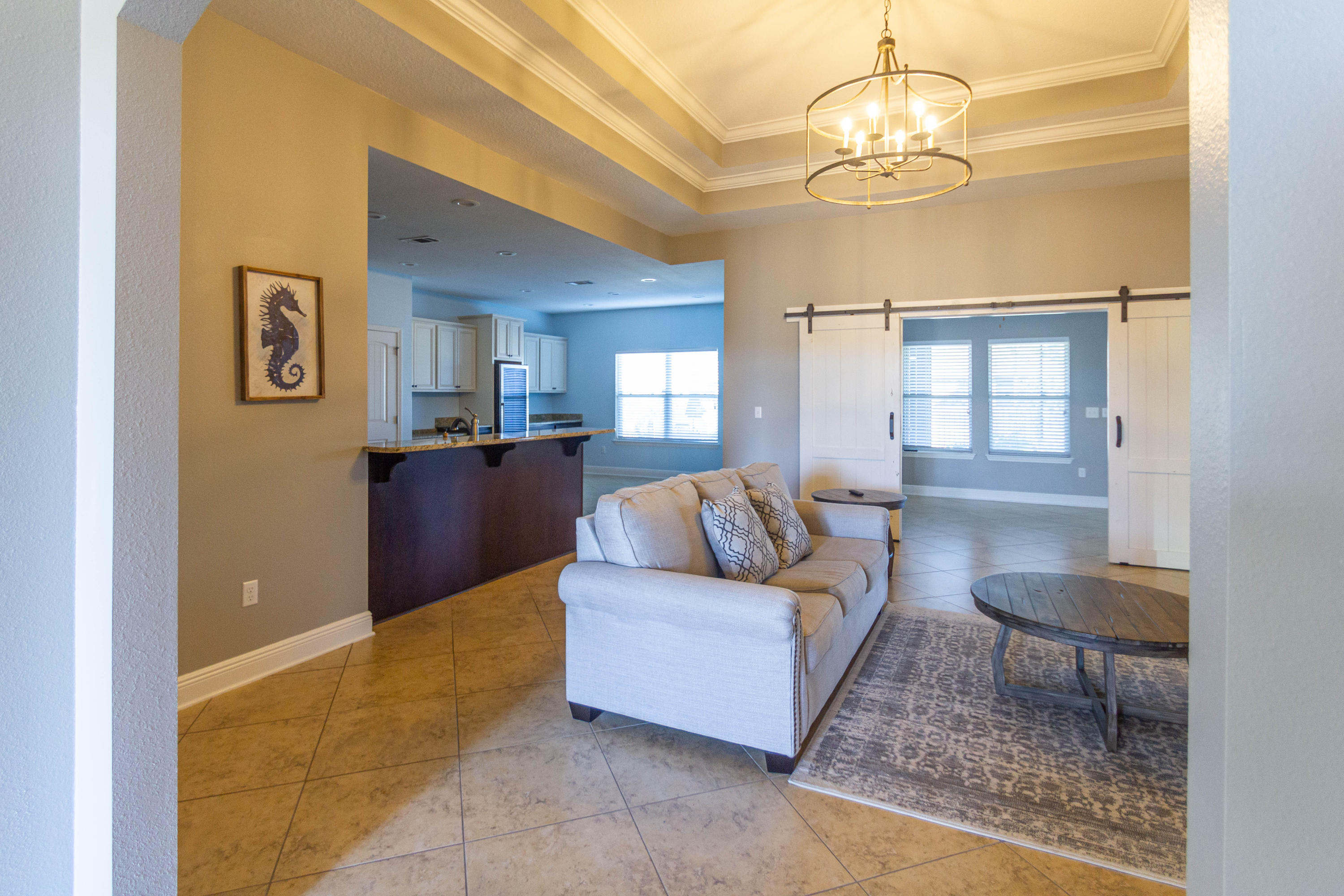 Featuring the best floorplan built in Driftwood Estates. This brick home is immaculate and ready to move in. You are central to everything here, Beach, shopping,hospital. This home was made for entertaining as you walk in you notice the archway and open floor plan. The triple tray ceilings in the living room add character to the huge kitchen area complete with a wine fridge surrounded by custom built cabinets. Stainless steel appliances and granite countertops. Master bedroom also has tray ceilings,custom shelving in walkin closet and a picture window looking into the big backyard. Barn doors off LR take you into a den/office area leading to Screened in porch The backyard has extensive brick pavers great area for entertaining. All TV's convey. 2 car garage with builtin cabinets.