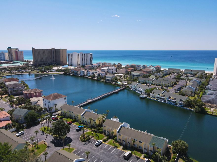 $38k in Rental Projections-Sleeps 10! UNIT 50 is a beautifully renovated condo directly south of Highway 98 with a quick walking distance across South Bay's very own boardwalk over the water to the famous sandy white beaches of Destin.  This 2 bedroom with hallway bunk beds has 3 bath and boast all new furniture, new ceiling fans in both bedrooms, new patio furniture on both decks, new energy efficient hurricane proof glass windows and slding glass doors, brand new paint, as well as an assigned parking space directly in front of the unit. Deeded beach access with beach chair service! You can sit on your new porch swing on your private covered patio overlooking this peaceful 5-acre fresh-water lake each morning watching the sunrise. There are gorgeous views of the water from both the main living area and the Master bedroom which also features a beautiful new shiplap wall.  The perfectly secluded community is bursting with wildlife and offers a short walking distance to local shops, restaurants and the local water-park Big Kahunas. South Bay includes 2 swimming pools, 2 kiddy pools, lighted tennis courts, beach side access, BBQ pits and a lake. Ideal for all tourist attractions. If you have been looking for the perfect vacation rental for your family and a great investment, this is it. Please contact us today to see a full list of the upgrades.  Buyer's to verify  dimensions.