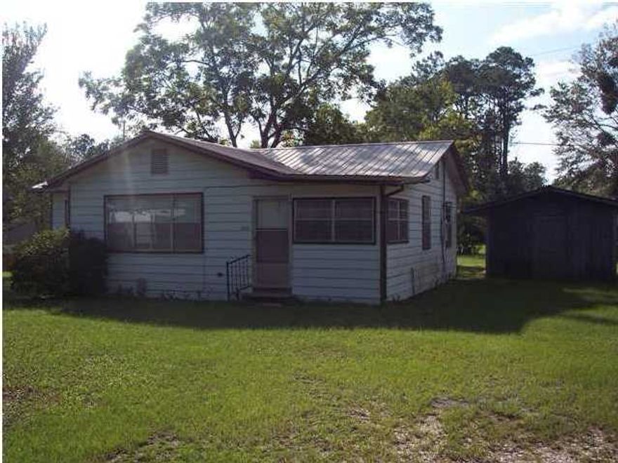 PRICED REDUCED FOR IMMEDIATE SALE...77 acres on Business Highway 331 across from Freeport Elementary School. 1,188 sf frame residence and a 720 sf storage building/garage. Property has new wooden fence on the north side of property. Property is in need of a HVAC system and repair work. Property is zoned mixed use in the City of Freeport. All information to be verified by buyer during due diligence.