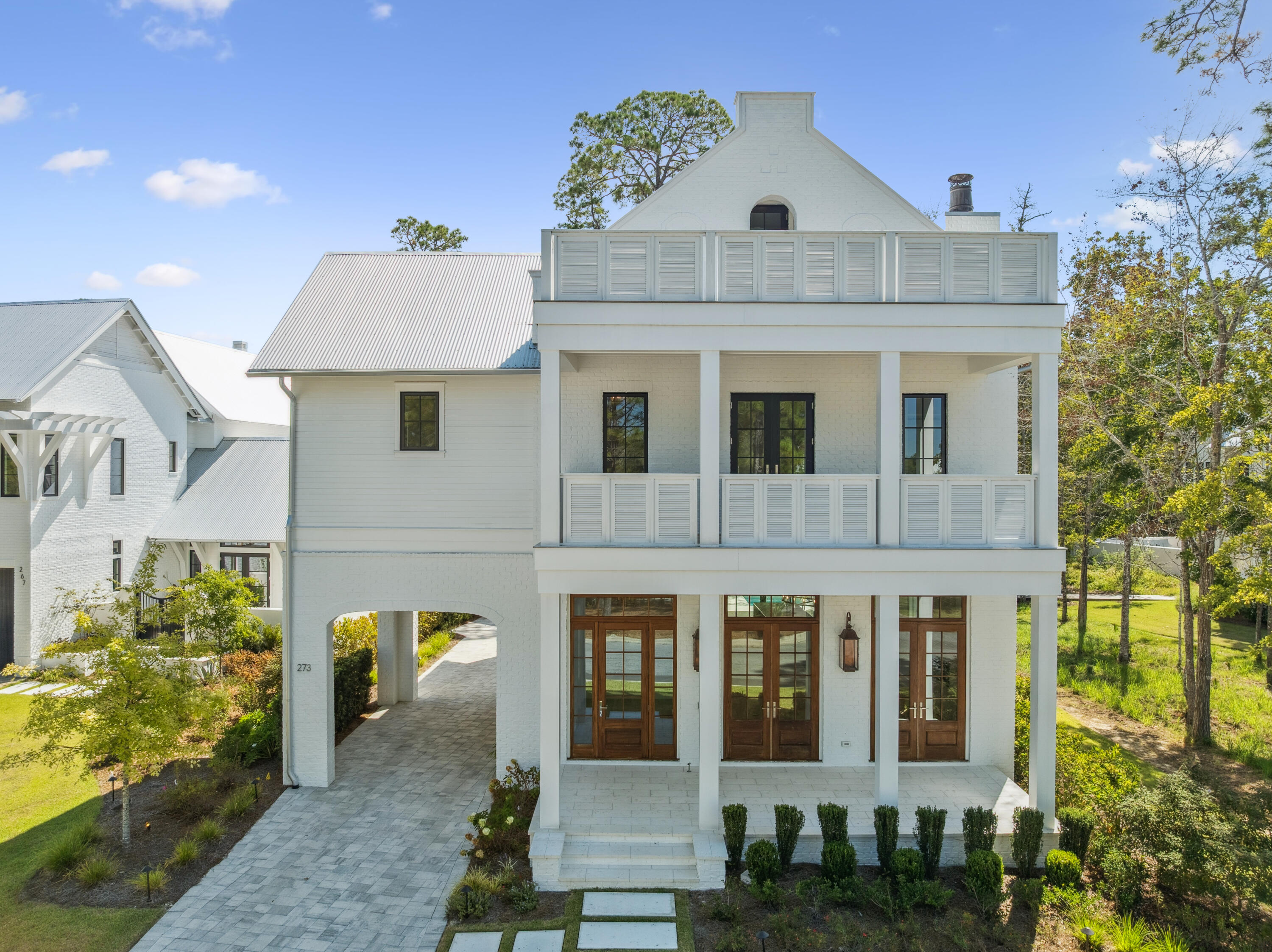 Set within the private gates of Churchill Oaks, 273 Churchill Oaks Drive blends thoughtful design, versatile living, and effortless access to the coastal lifestyle. Located in this premier bayfront community, the home offers over 4,000 square feet of refined living space, including four bedrooms, four-and-a-half bathrooms, and a private carriage house--perfect for guests, extended family, or a dedicated home office. The spacious great room, anchored by a gas fireplace and framed by an abundance of windows and doors, sets the tone for the home's mix of traditional elegance with modern touches.
The custom chef's kitchen, equipped with Miele appliances and quartz countertops, flows seamlessly to the outdoor entertaining area, complete with a private pool and summer kitchen, making indoor-outdoor living effortless. A private elevator or the beautifully designed staircase leads to the second floor, where the master suite boasts a balcony overlooking the bayou and a spa-inspired bathroom with dual vanities, a soaking tub, and a walk-in shower. Three additional bedroom suites continue the theme of wide-plank floors, custom cabinetry, and clean, crisp tile throughout the home. The third-floor space offers flexibility as a gym, theater, library, or additional sitting area.
The carriage house is a true bonus, featuring its own kitchenette, living room, and separate bedroom, providing privacy and comfort for visitors or anyone needing personal space. Multiple covered porches, open patios, and poolside living ensure the home's outdoor spaces are as inviting as the interiors. Residents also enjoy access to Churchill Oaks' resort-style amenities, including a bayfront clubhouse, fitness center, and a deep-water marina with 36 private boat slips.
273 Churchill Oaks Drive isn't just a home - it's an invitation to embrace the relaxed elegance and endless possibilities of life on the Emerald Coast.