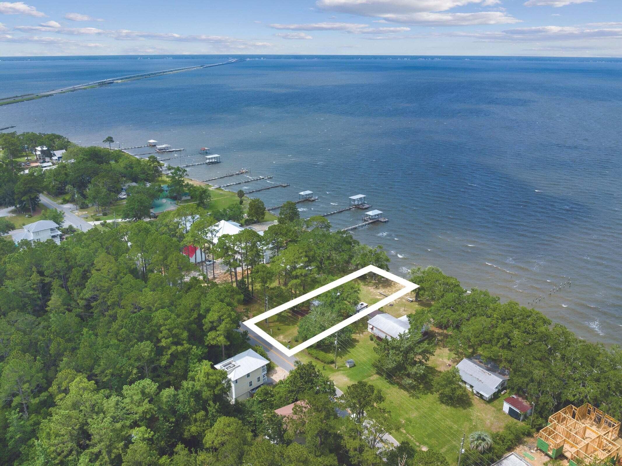 Discover the perfect waterfront lot on the Choctawhatchee Bay, offering breathtaking sunsets year-round. With a rip rap retaining wall already in place, this prime location provides serene privacy while delivering open views and direct access to both the bay and the Gulf. Ideal for building your dream home, this property blends peaceful seclusion with convenience. At the end of the street, Grady Brown Park provides many amenities including a kayak launch and two boat ramps with parking for boat trailers. Lastly, this location is just a short 10 to 15 minute drive to local shops, schools, restaurants, 30A and Grayton Beach. Make the bay your backyard oasis!