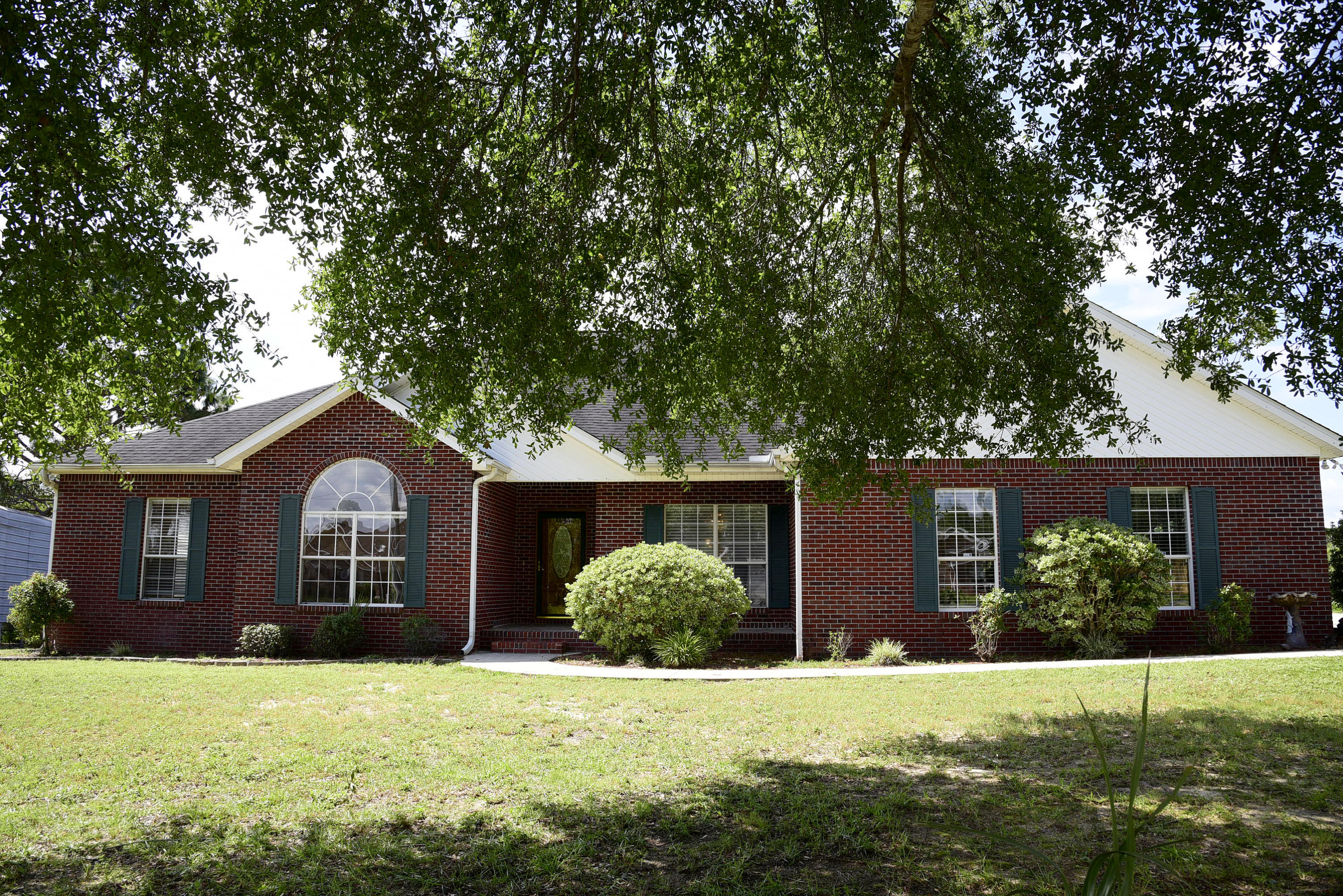 This all brick lakefront home also has a NEW ROOF and a tankless Rinnai water heater! The beautiful kitchen has lots of wood cabinetry, a dual fuel gas range with electric double ovens and center island. Enjoy the great room featuring a vaulted ceiling and a wood burning fireplace. The master suite has a large walk-in closet and adjoining bath with separate shower. Imagine yourself enjoying the heated and cooled Florida room overlooking the private lake. A handy 16x16 storage shed with double doors is the perfect spot for lawn equipment and pull down stairs in the garage access the attic with decking for extra storage. Don't miss this opportunity to own your own private oasis!