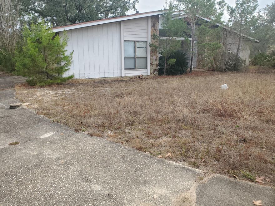 This 3BR/2BA is located in the desirable Holly by the Sea subdivision just off the East Entrance.  With a little imagination and some TLC this home has limitless potential.  Nestled in a .75 acre lot. HOA dues are only $445 annually and include use of the huge recreational facility across HWY 98.