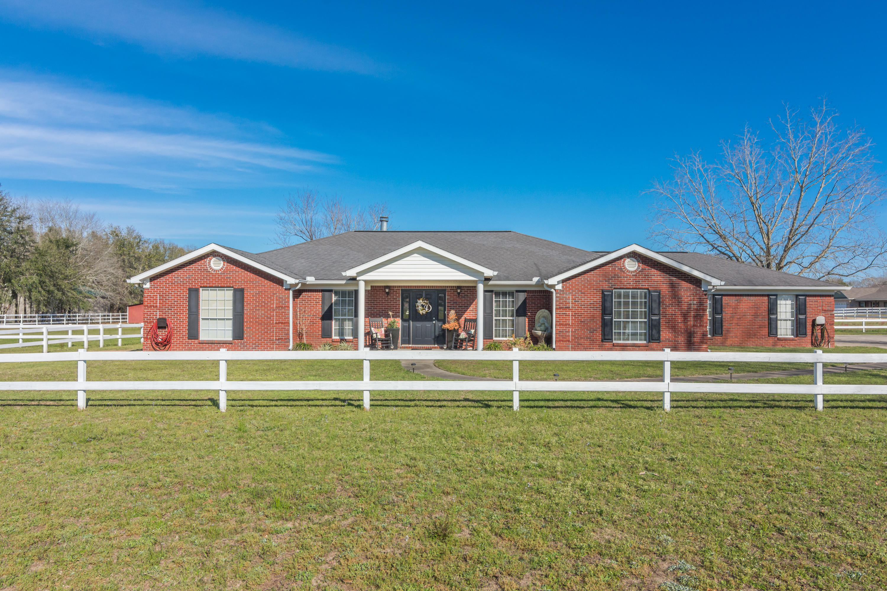 Southern elegance & 5 acres, you can even bring your horses!. This 3 bedroom, 3 bath (yep everyone has their own bath!), split floor plan invites you in, the moment you walk up. Tiled foyer opens to large living room w gas fireplace & gorgeous engineered wood floors, with formal dining on one side, office on the other. Kitchen has stainless appliances, large pantry, breakfast bar and large eat-in area flanked by windows, light and bright! Doors from the kitchen and living room lead to a huge outdoor decked & covered entertainment area. Perfect year round for bbq's, ball games and visiting with friends! Master bedroom has large walk-in closet, master bath has double vanities, garden tub and separate shower. Speakers are throughout the house. Gas and electric as well.