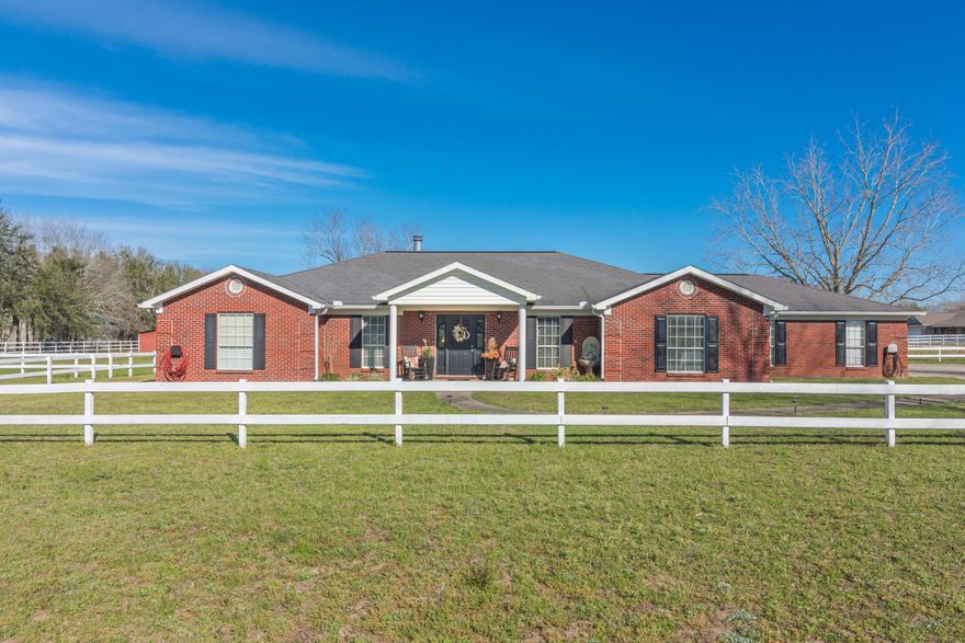 Southern elegance & 5 acres, you can even bring your horses!. This 3 bedroom, 3 bath (yep everyone has their own bath!), split floor plan invites you in, the moment you walk up.  Tiled foyer opens to large living room w gas fireplace & gorgeous engineered wood floors, with formal dining on one side, office on the other.   Kitchen has stainless appliances, large pantry, breakfast bar and large eat-in area flanked by windows, light and bright! Doors from the kitchen and living room lead to a huge outdoor decked & covered entertainment area. Perfect year round for bbq's, ball games and visiting with friends! Master bedroom has large walk-in closet, master bath has double vanities, garden tub and separate shower.  Speakers are throughout the house. Gas and electric as well.