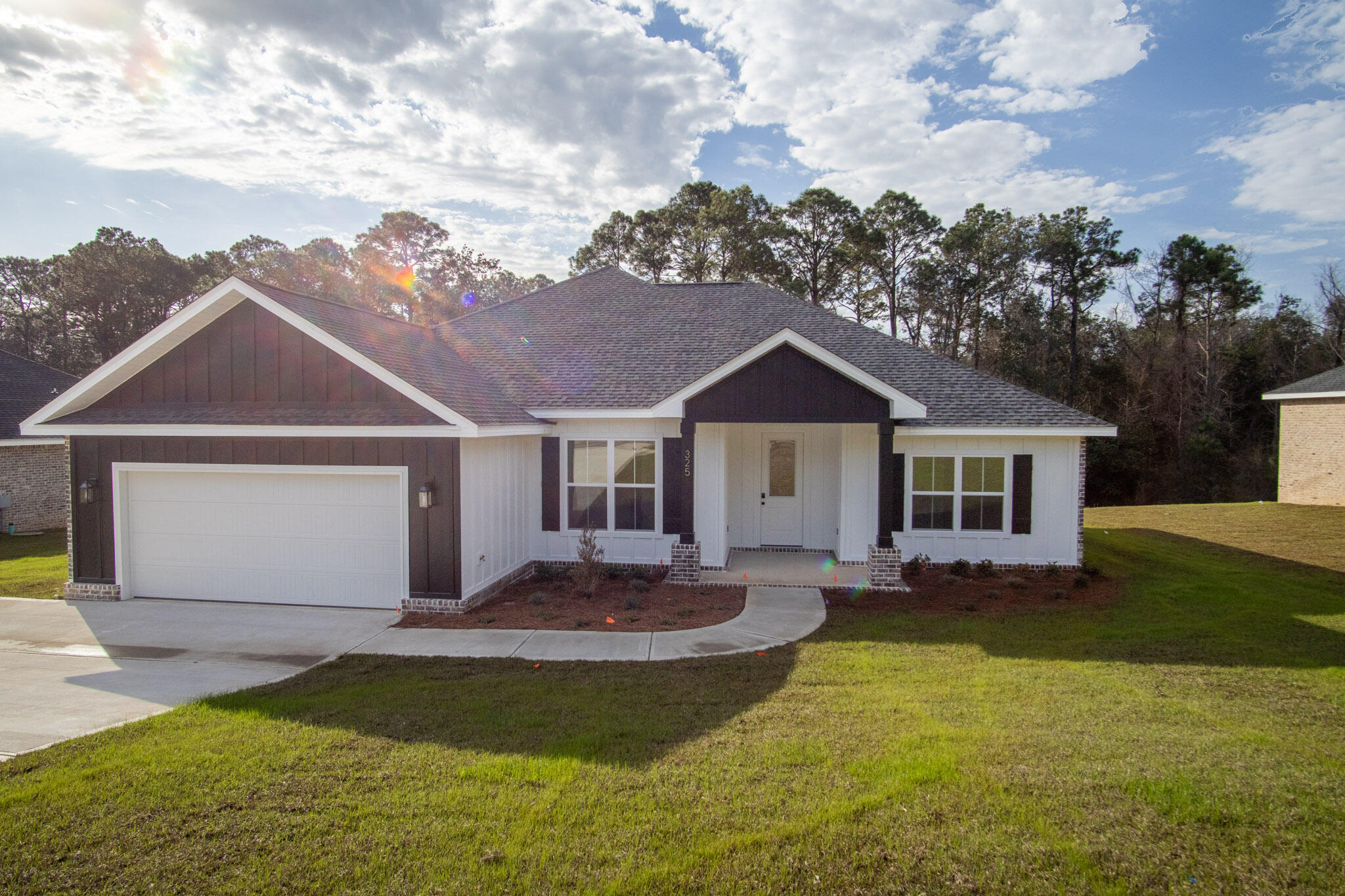 This newly built 4-bedroom, 2.5-bath home features a brick and Hardie exterior with an open floor plan designed for comfortable living and entertaining. Situated on a large lot at the south end of Crestview, the home is convenient location for access to Hwy 85, I-10, Crestview Commons, shopping, dining, schools, and medical facilities. The property borders land recently acquired by Okaloosa County, which has proposed plans for a public park. Some photos may reflect similar homes built by the same builder for reference.