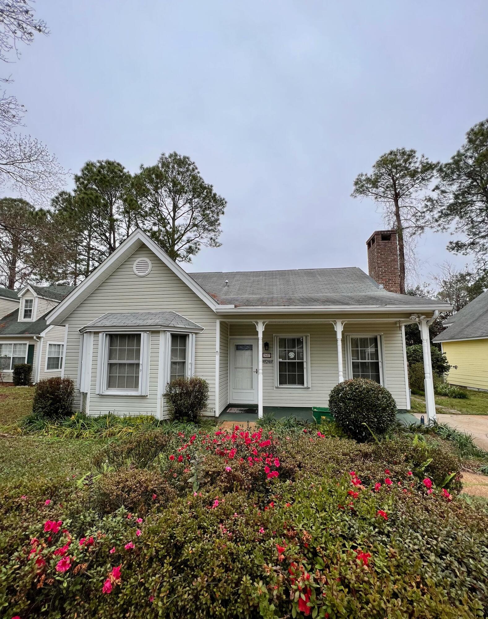 Adorbable 4 bedroom, 2 bath, one owner cottage home nestled in central Fort Walton Beach.Featuring great curb appeal with landscaped flower beds, and a covered front porch- perfect for rocking chairs and sipping sweet tea. As you enter the home you'll be greeted with a spacious living room with a cozy wood burning fireplace. Kitchen with breakfast nook, and an abundance of countertop space, and white cabinetry. Just off the breakfast nook through glassed french doors is a wonderful Florida room, overlooking the fenced backyard.Main level primary bedroom with delightful bay window, walk in closet, and en-suite walk-through bathroom with tile flooring and beautiful cultured marble shower. One additional bedroom located on the main level. Upstairs you'll find two spacious bedrooms, and a