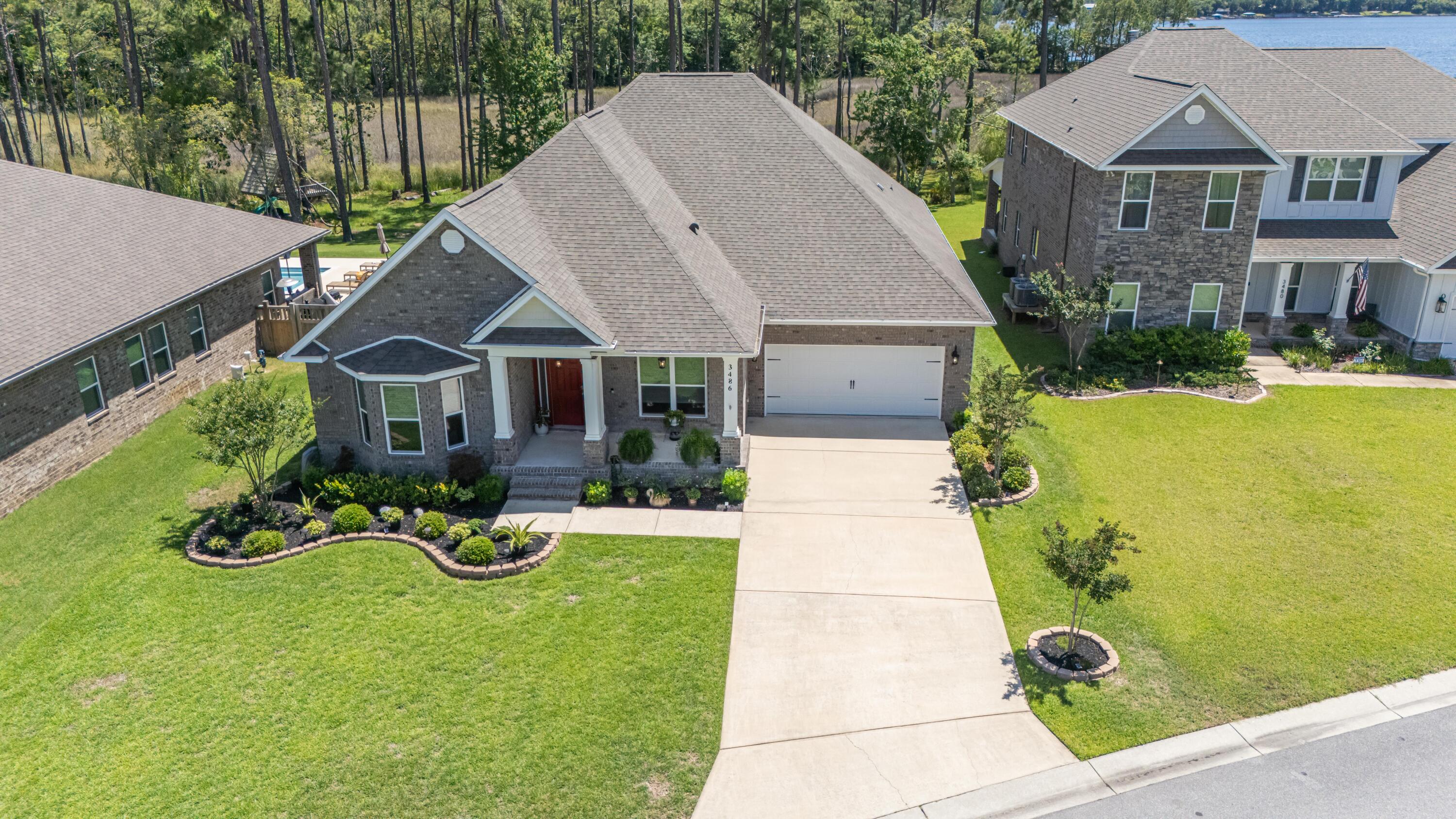 This 2019 5 bedroom 3 bathroom waterfront home is an outdoorsman's paradise! Situated on a double lot totaling .79 acres, this beautifully crafted 3127 sq ft retreat in Navarre is close enough to be convenient to shopping (10-15 min to Navarre shopping), recreation (15 min to Navarre Beach), and work (20 min to Hurlbert Field) while still offering access to nature via the property's dock on Poplar Creek leading to East Bay. Enjoy unparalleled views and sunsets, fishing, and water sports right off your backyard! Inside the home boasts an open concept plan, including a split floor plan lending privacy to the bedrooms. Other amenities include:Kitchen islandSolar tubes for natural light in the kitchenGranite countertopsStainless steel appliancesSpacious master closet