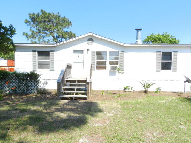 Great investment property in nice community close to Hurlburt AFB. Mobile Home built in 1996, 1040 sq. ft., 3 bdrm, 2 bth, with fireplace, open and split floor plan. Features Kitchen with Hardboard Decorative Siding, Gas 4 burner range, Stainless Steel Fridge, dishwasher, laundry room hookup, Natural Gas heat and central air, large walk-in closet in the master, laminate flooring, new carpet and padding. Exterior features: front porch, storm door, sprinkler pump, sprinklers, 3/4 of the yard fenced, just needs connection fence on both sides. Level yard, home surrounded by newer constructed brick home, close to Schools, shopping, Beaches, and easy access to hwy 98. This is a good investment property and a good starter home. Could be for anyone, worth checking this one out. A must see!