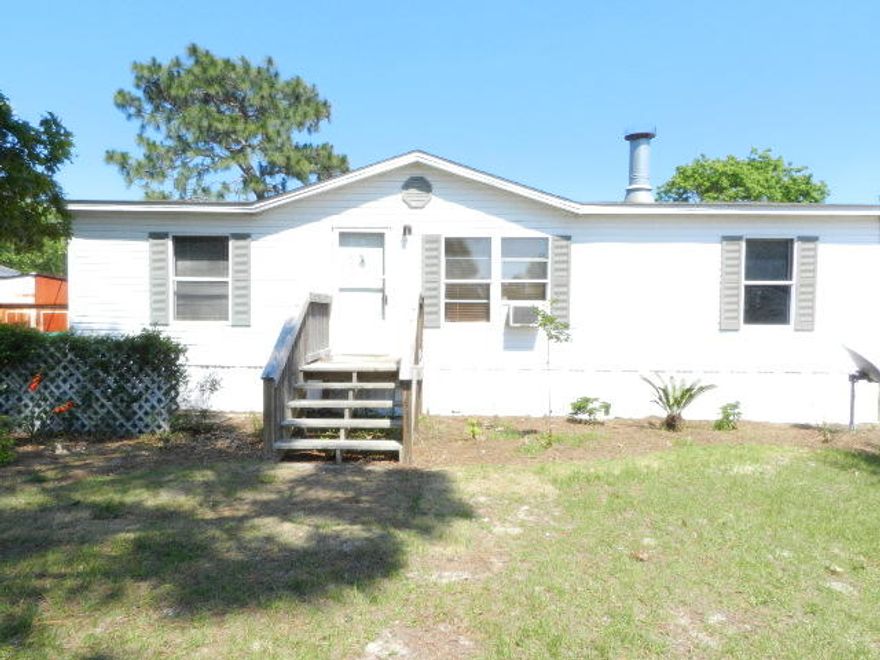 Great investment property in nice community close to Hurlburt AFB. Mobile Home built in 1996, 1040 sq. ft., 3 bdrm, 2 bth, with fireplace, open and split floor plan. Features Kitchen with Hardboard Decorative Siding, Gas 4 burner range, Stainless Steel Fridge, dishwasher, laundry room hookup, Natural Gas heat and central air, large walk-in closet in the master, laminate flooring, new carpet and padding. Exterior features: front porch, storm door, sprinkler pump, sprinklers, 3/4 of the yard fenced, just needs connection fence on both sides. Level yard, home surrounded by newer constructed brick home, close to Schools, shopping, Beaches, and easy access to hwy 98. This is a good investment property and a good starter home. Could be for anyone, worth checking this one out. A must see!