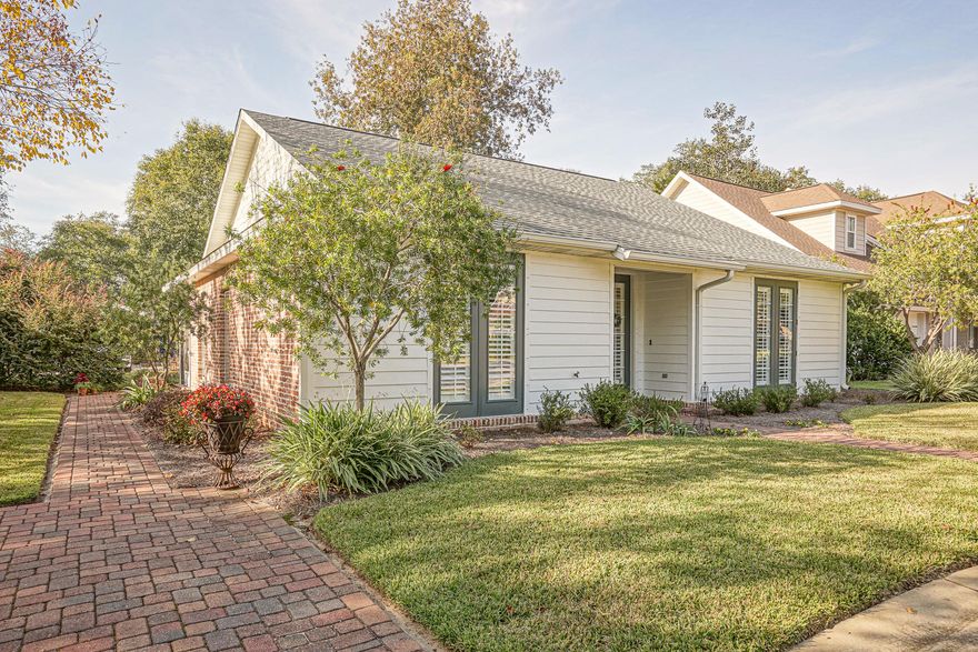 Looking for a charming cottage in the heart of Niceville? This lovely home sits along a cul-de-sac in a quiet and friendly neighborhood decorated with street lamps, brick pavers, and mature trees. Upon entry you are greeted with gorgeous walnut colored hardwood flooring and plenty of natural lighting shining through custom plantation shutters. The great room opens up to a large office space, which can easily be converted into a 3rd bedroom if desired. The kitchen is equipped with all stainless steel appliances, granite counter tops, and bar seating, along with plenty of cabinet space for storage needs. Each bedroom maintains a private bathroom with a tiled shower (2nd bedroom has a tub/shower combination) and granite counter tops. The master bedroom is a show stopper and includes a