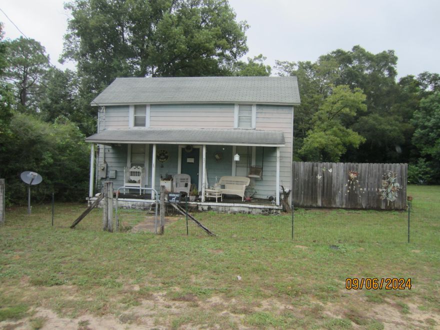 This two-story home was built in 1900.  It is a 3BR/1BA with a beautiful level lot.  The property is fenced, and there is a significant amount of  deferred maintenance.  There are two bedrooms upstairs.  Every feature in the home is quaint and reminiscent of ''days gone by''. Great investment opportunity.  There are two lots with the home sitting on one and the vacant lot adjoining.  Home was rewired in 1997 and has central A/C & heat.  Public water & sewer.