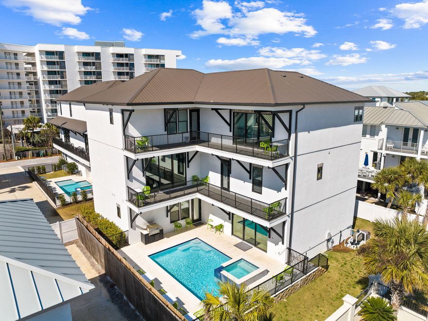 Experience luxury living in this expansive and breathtaking modern beach home designed to maximize rental revenues and Gulf views! Nestled in a sought-after, gated community of Miramar Beach, literally steps from the white sands of your deeded beach access, 211 Snowdrift Road is a recently constructed masterpiece boasting over 5919 sq. feet of living space, 9 opulent bedrooms, 9 full bathrooms, and 2 half baths with an elevator. On the 1st level, indulge in comfort with 3 king suites, a cozy living room, and the added delight of an in-home theater featuring a large screen, recliners with drink holders, and extra bean bags for casual seating and laundry. Step outside to a glittering pool, a centerpiece hot tub, and a spacious fenced-in backyard with ample grilling and dining accommodation The second level unveils the main living space, featuring a primary living room, a stunning chef's kitchen, and additional 2 king suites - one with access to the shared balcony and a view of the Gulf. Floor-to-ceiling windows flood the open floor plan with natural light, providing access to a long balcony overlooking the neighborhood and offering another view of the Gulf. The swanky living room is adorned with luxurious fabrics, bold patterns, and pops of cheerful color. The bar and dining area create the perfect setting for gathering and entertaining, equipped with a large professional refrigerator, a Viking six-burner gas stove, and ample pantry space.

The top level offers privacy and retreat with the primary bedroom, a spacious laundry room, and 3 more king suites - two with balcony access and water views. A bunk room with two sets of twin/full bunks and a private ensuite adds versatility and fun for the young or young at heart. The primary king suite includes access to the shared balcony and a lavish ensuite with dual sinks, a large spa shower, and a garden tub for relaxation...as well as stunning Gulf views.

Conveniently situated south of US Hwy 98, in a private, gated enclave adjacent to the Silver Sands Outlets, 211 Snowdrift Road is just minutes away from luxury shops and dining at Grand Boulevard. Enjoy a very short stroll to the beautiful beaches of South Walton with deeded beach access literally steps from the home. This is a unique opportunity to embrace the epitome of coastal living in a meticulously designed and thoughtfully curated residence.