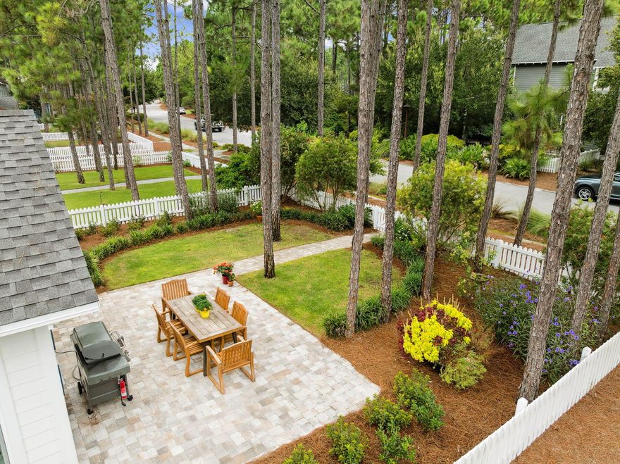 This charming Huff Bayberry floor plan sits on one of the PREMIER lots in the sought-after Winter Garden Phase at the front of Watersound Origins. The serene backyard is the highlight--surrounded by tall pines, mature oak trees, and lush established landscaping that create a sense of history and timeless beauty. Adding to the serenity there is a spacious paver patio (with a gas line hookup to the grill that will stay), and a cozy screened porch overlooking this private oasis; outdoor living is unmatched. There is even room for a POOL! Located on Jack Knife Drive--only two blocks long with minimal traffic--the home provides both privacy and convenience. The home backs to a quiet, low-traffic 1 block street, allowing for direct access to the backyard. This Phase of Origins features meandering walking paths through park-like landscaping and convenient parking pads throughout. Since it is located at the front of the neighborhood, there is easy access to Highway 98 and the Watersound Town Center. 
Freshly updated with new hardwood flooring (2024), fresh paint, and exterior power washing, this home is move-in ready. The gourmet kitchen has been refreshed with new countertops and backsplash, stainless steel appliances (including a Fisher Paykel dual drawer dishwasher), a pantry, and a dry bar with abundant cabinetry and dual freezer drawers. The open-concept layout allows for seamless entertaining with family and friends.
Offering 3 bedrooms and 3 full baths, the popular Bayberry plan blends flexibility with comfort. The middle bedroom is a collector's dream with floor-to-ceiling built-in bookcases, perfect for showcasing treasures or repurposing as an office/den. The oversized primary suite offers room for a bed, nightstands, dresser, and sitting area, while the primary closet includes custom wood built-ins for storage and organization.
Additional features include a Generac Generator, separate laundry room, epoxy garage floors, automatic irrigation system and wiring for surround sound. 
Priced to sell quickly, this home combines one of the best lots in the neighborhood with thoughtful updates, mature landscaping, and desirable upgradesmaking it a rare find along 30A.