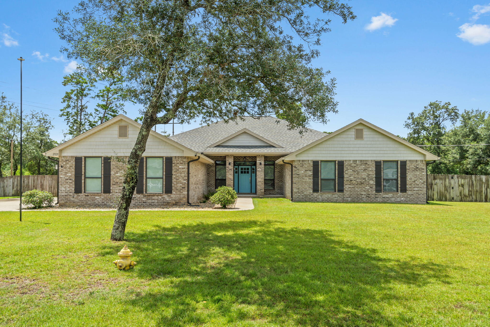 Welcome home your MINT condition all-brick custom 4BD/3.5BA home on a spacious 0.82-acre lot in the popular Navarre neighborhood of Holley by the Sea community! Have peace of mind with a home built in 2020. This thoughtfully designed over 3,000 sqft property features a dedicated office with French doors, a massive living room. Pull in and appreciate the 3 car garage, extended extra-wide driveway pad with access to the double gate, perfect for pulling in your boat! Walk inside and you'll immediately love the large open living room and hard surface flooring extending throughout! The huge kitchen boasts granite countertops, black stainless steel appliances, a large island with bar seating, a walk-in pantry, and an oversized eat-in area. Enjoy coming home to your expansive primary suite, complete with a tray ceiling and an en suite offering two walk-in closets, granite double vanities, and a tiled walk-in shower. Three additional bedrooms offer generous space and oversized closets. Two of the three can easily fit KING-size beds. Supported by two well-appointed bathrooms with granite counters and tile flooring. Walk through the large pantry to the laundry room, which includes a convenient half bath and outdoor access to the backyard. Enjoy relaxing (bug-free!) on the 18x8 screened porch or experience the best of Florida living. Roast s'mores over the fire pit, grill, and make memories on this fantastic property. Not only are you close to the Emerald Coast's sugar white sand beaches, but as a property owner, you have access to top-tier amenities at Holley by the Sea's multi-million dollar recreation center!
Key Highlights:
"
" 4 Bedrooms + Den/office | 2.5 Bathrooms | Over 3,000 Sq Ft (One Level)
" No Carpet! Upgraded COREtec LVP Flooring Throughout entire house
" Two Expanded Bedrooms (+5 ft each)
" Oversized Kitchen with Newer GE Profile Appliances
" 3-Car Side-Entry Garage - Naturally Screened from Road
" Nearly 1 Acre Fully Fenced Corner Lot (sided by Undevelopable Land and backs up to wood lot for more privacy)
" High Ceilings, Split Floor Plan, Large Walk-In Shower in Master
" Soffit Lighting + Permanent App-Controlled Holiday Lighting
" Built in 2020 - Energy-Efficient and Low Maintenance
" Holley by the Sea Amenities: Pools, Fitness Center, Clubhouse, Tennis, Private Boat Ramp, Waterfront Access
"
" Zoned for Top-Rated East Bay K-8 and Navarre High School
Description:
Nearly one-acre private corner lot in the highly desirable Holley by the Sea community. This move-in-ready 4-bedroom, 2.5-bath home with a dedicated office/den offers space and privacy.
Two secondary bedrooms have been expanded by 5 feet, offering rare flexibility for growing families, guests, or work-from-home needs. The side-entry 3-car garage sits tucked behind mature vegetation and sit against undevelopable land, giving this home the privacy of a tucked-away estate with the amenities of a neighborhood.
NO carpet anywhere! The entire home features stunning white oak luxury vinyl plank flooring by COREtec, known for its durability, waterproof performance, and timeless beauty.
The open-concept floor plan is anchored by an oversized kitchen, perfect for anyone who loves to cook or entertain. It features newer GE Profile appliances, generous cabinet storage, and abundant counter space, all flowing effortlessly into the main living and dining areas.
The owner's suite is a true retreat, complete with double vanities and a large walk-in shower, while the split-bedroom design ensures privacy and quiet for everyone in the home.
Step outside and enjoy a fully fenced, nearly 1-acre backyard, ready for play, gardening, or future upgrades. Maybe a private pool? The home shines in the evening with elegant soffit lighting and features permanent holiday lighting that's app-controlled and fully customizable, with dozens of built-in themes or your own custom creations, right from your phone.